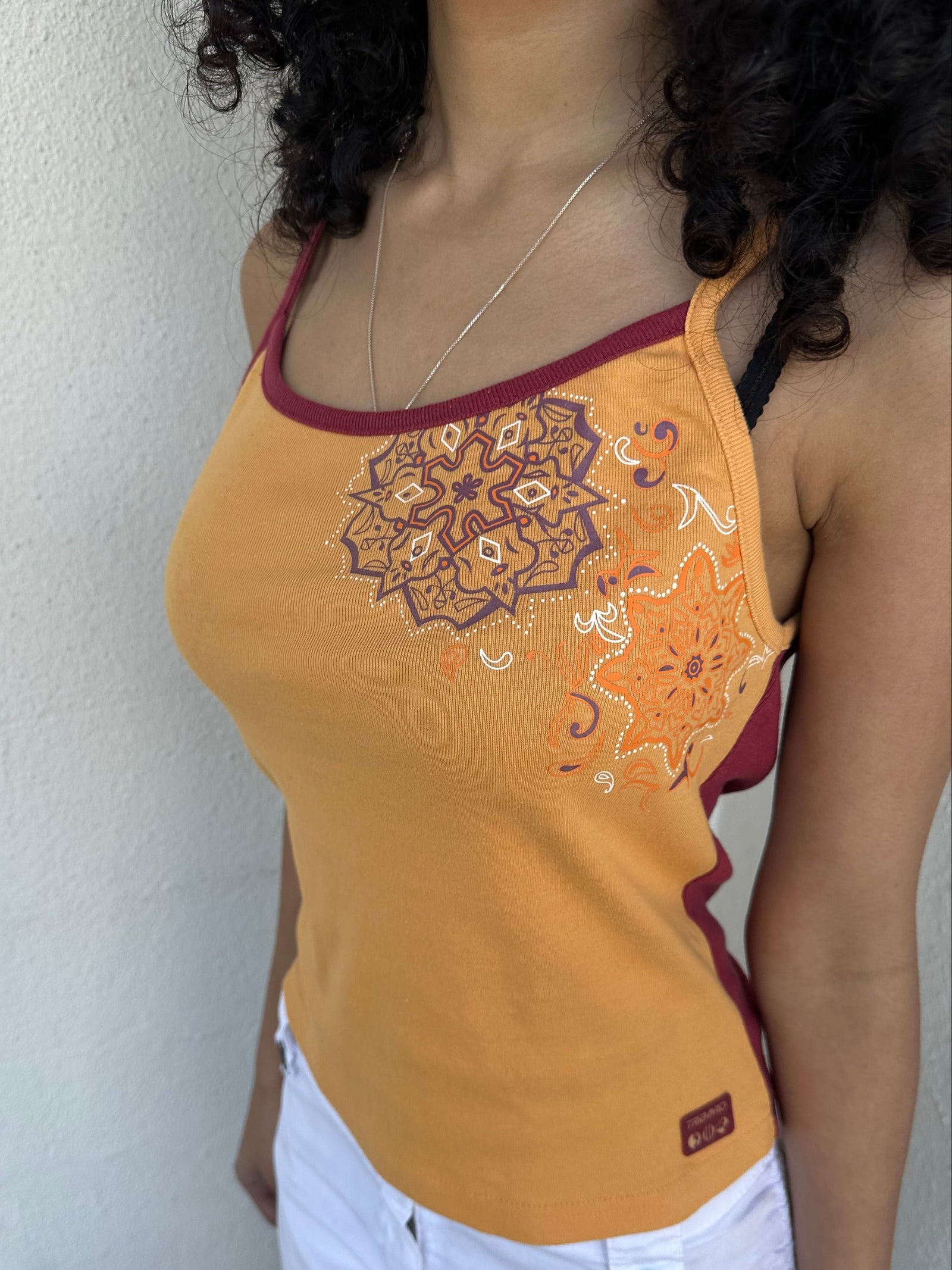 Woman wearing a Y2K 00s Orange & burgundy mandala print layered  cami