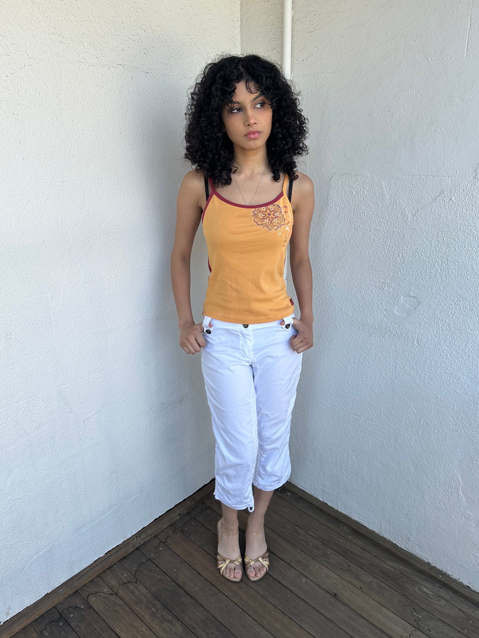 Woman wearing a Y2K 00s Orange & burgundy mandala print layered  cami