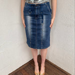 Woman wearing a Y2K 00s Pinstripe denim midi skirt featuring silver D-rings and grommet detailing across the front.