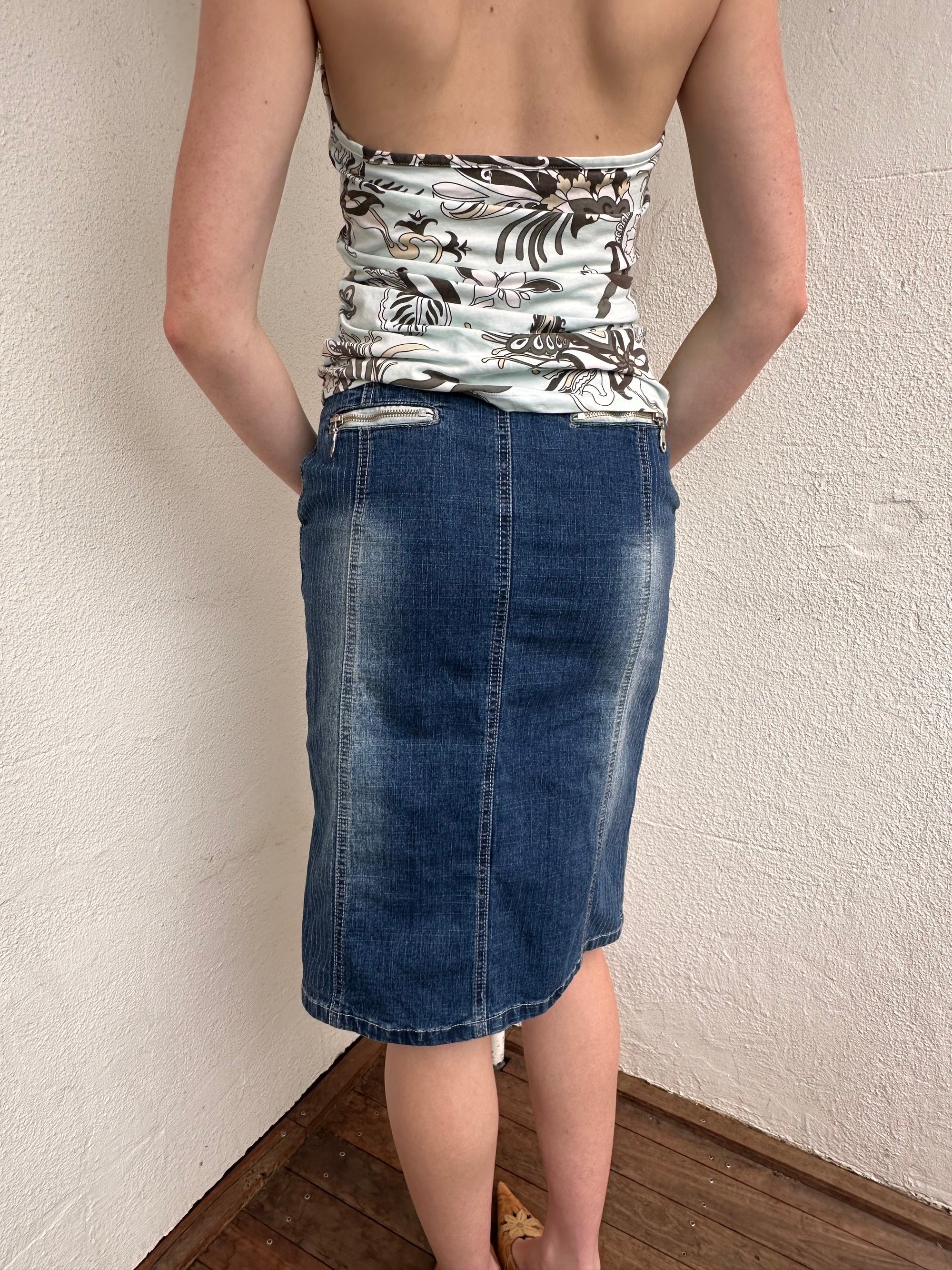 Woman wearing a Y2K 00s Pinstripe denim midi skirt featuring silver D-rings and grommet detailing across the front.