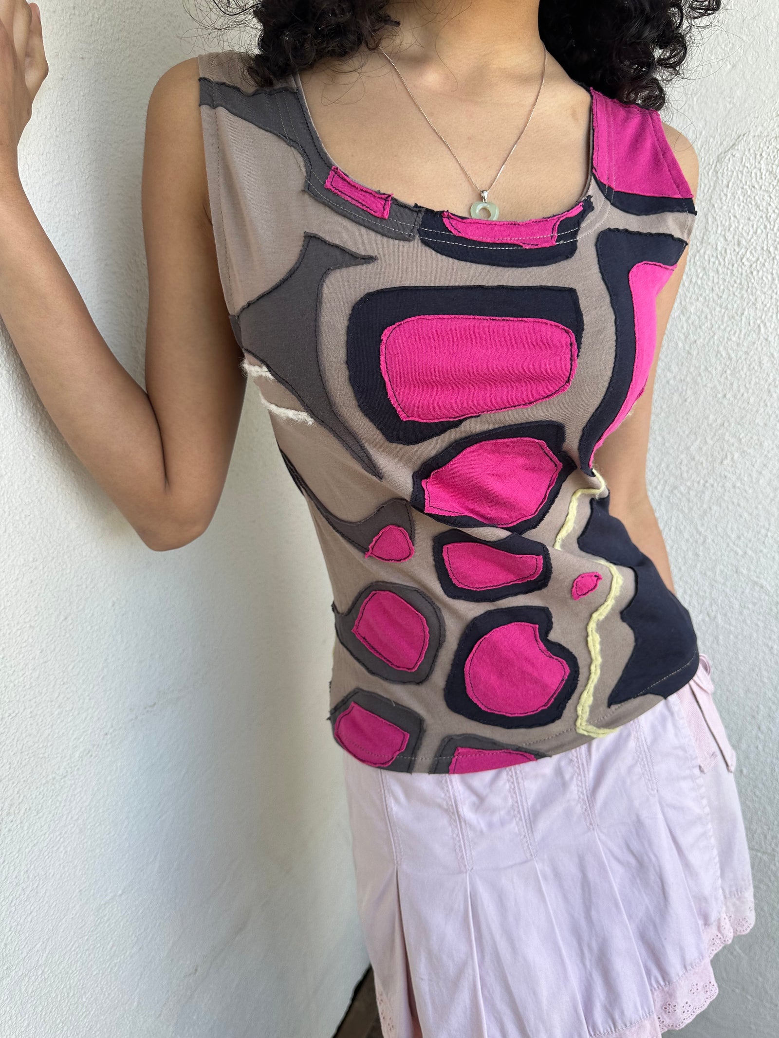 Hot pink, beige, and black appliqué patchwork tank crafted from soft stretch fabric with contrast stitching. 