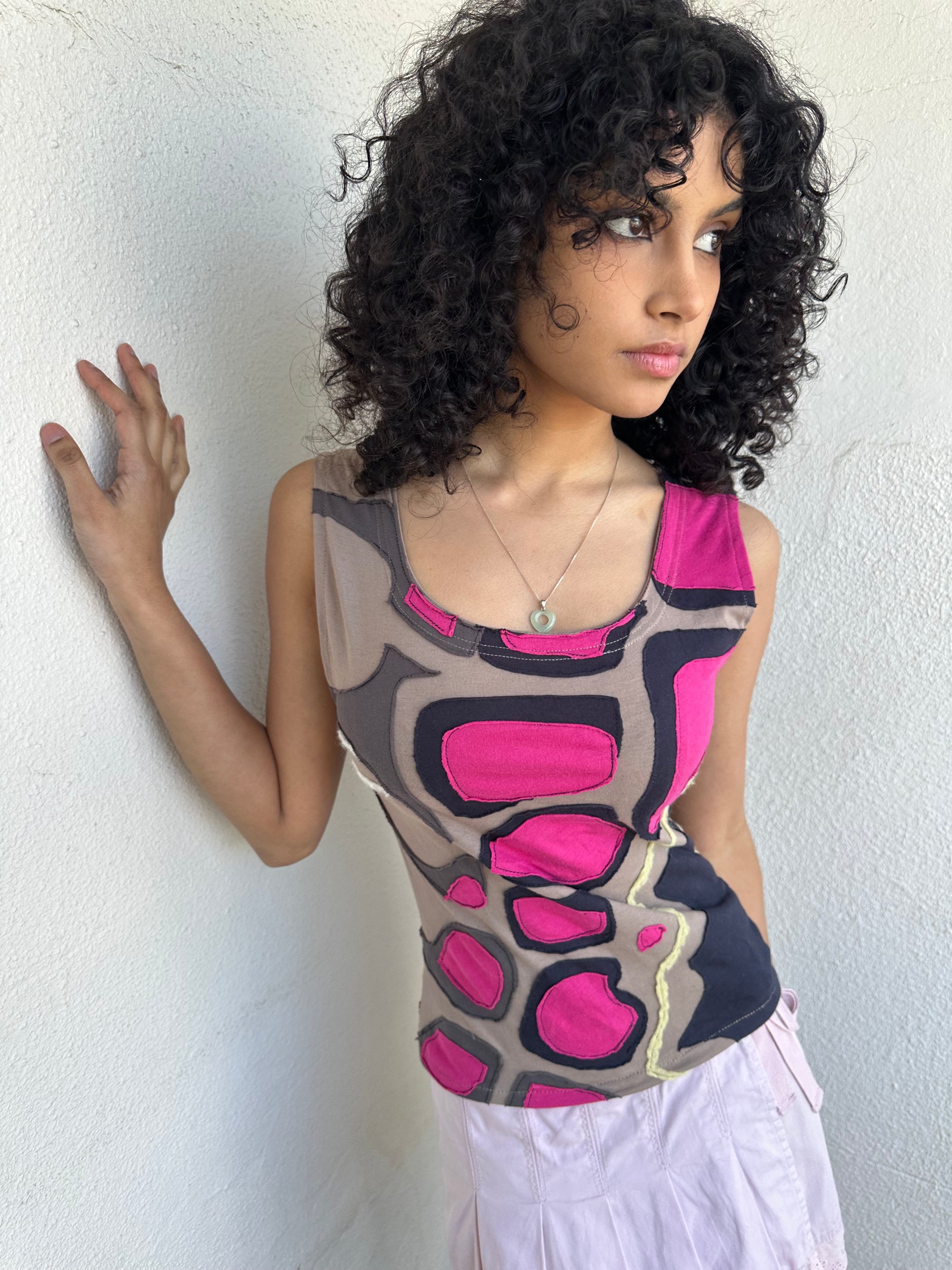 Hot pink, beige, and black appliqué patchwork tank crafted from soft stretch fabric with contrast stitching. 