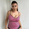 Woman Dressed in Y2K 00s Pink and brown stripe cami featuring a striped design in pink and brown tones with a pink rosette detail at the centre.