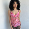 Woman wearing a Y2K 90s Beautiful pink floral mesh cami with a lace under bust cut-out and delicate embroidered flower detailing.
