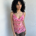 Woman wearing a Y2K 90s Beautiful pink floral mesh cami with a lace under bust cut-out and delicate embroidered flower detailing.