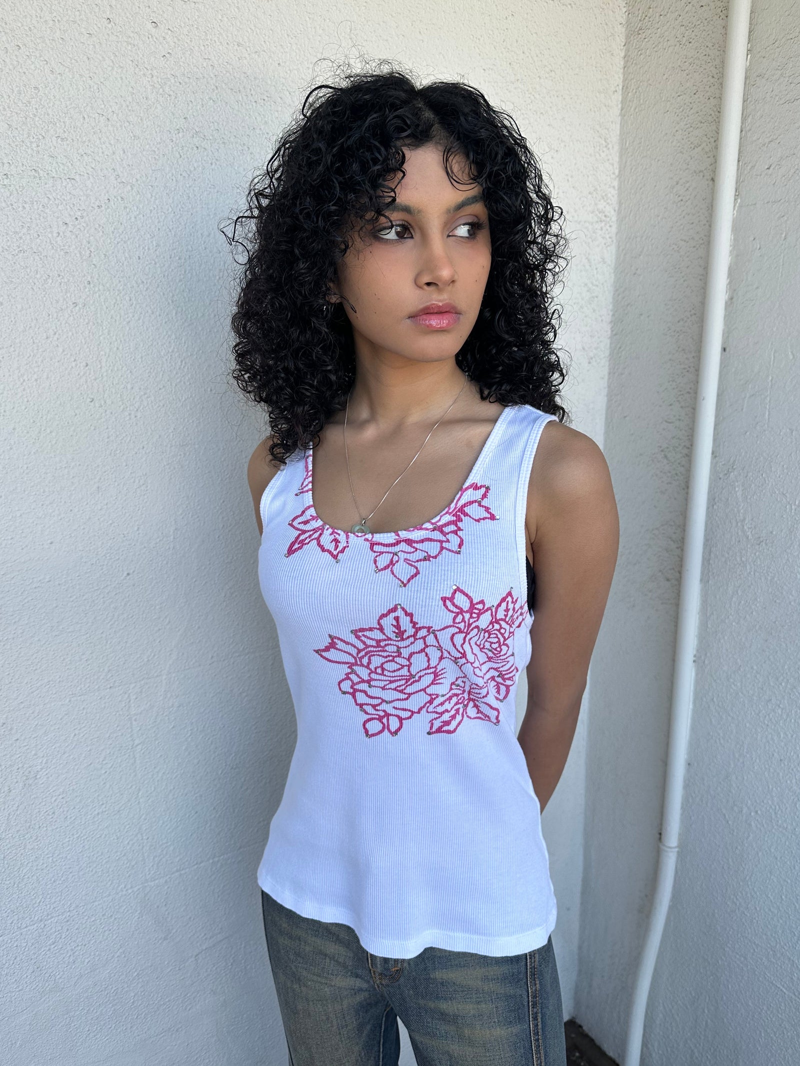 Woman wearing a Y2K 00s Hot pink flower print on white tank top features a vibrant floral graphic