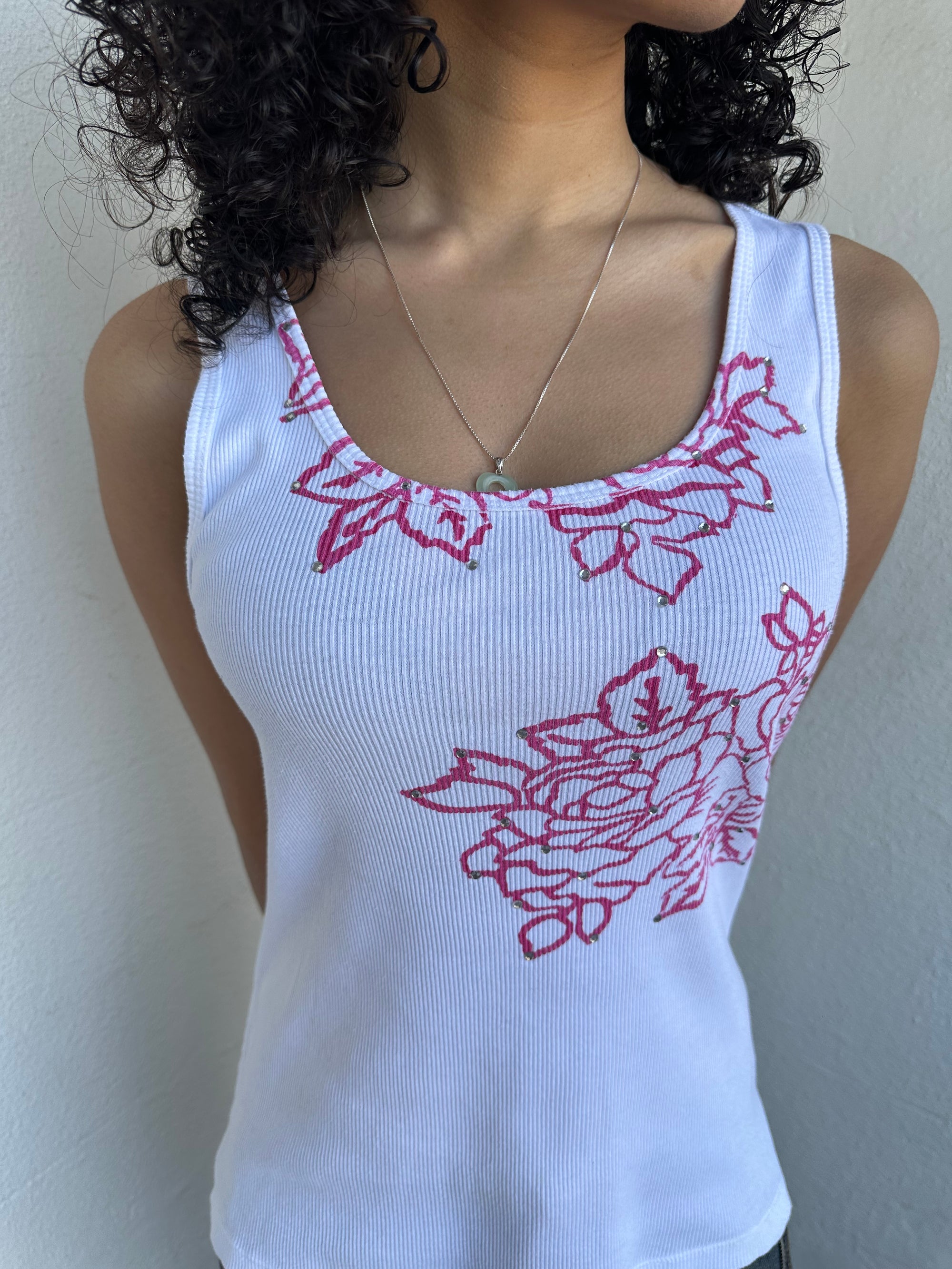 Woman wearing a Y2K 00s Hot pink flower print on white tank top features a vibrant floral graphic