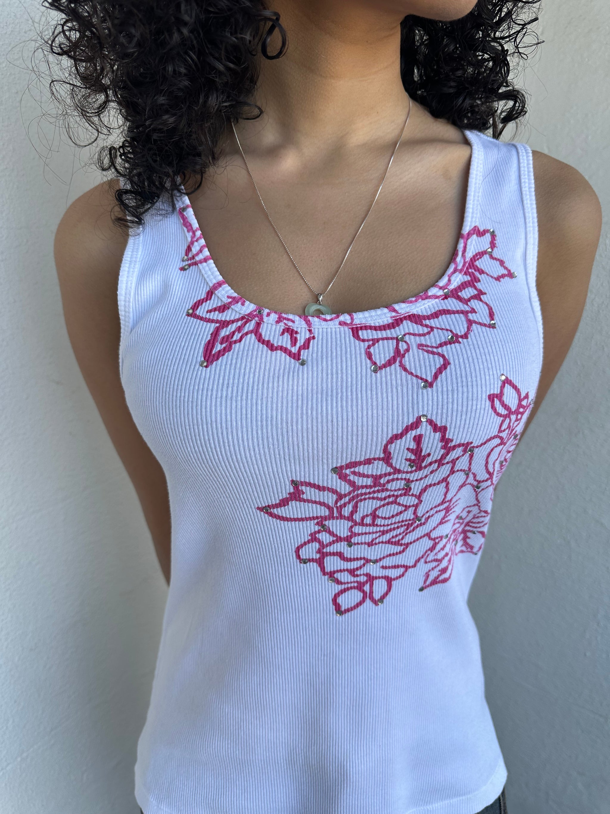 Woman wearing a Y2K 00s Hot pink flower print on white tank top features a vibrant floral graphic