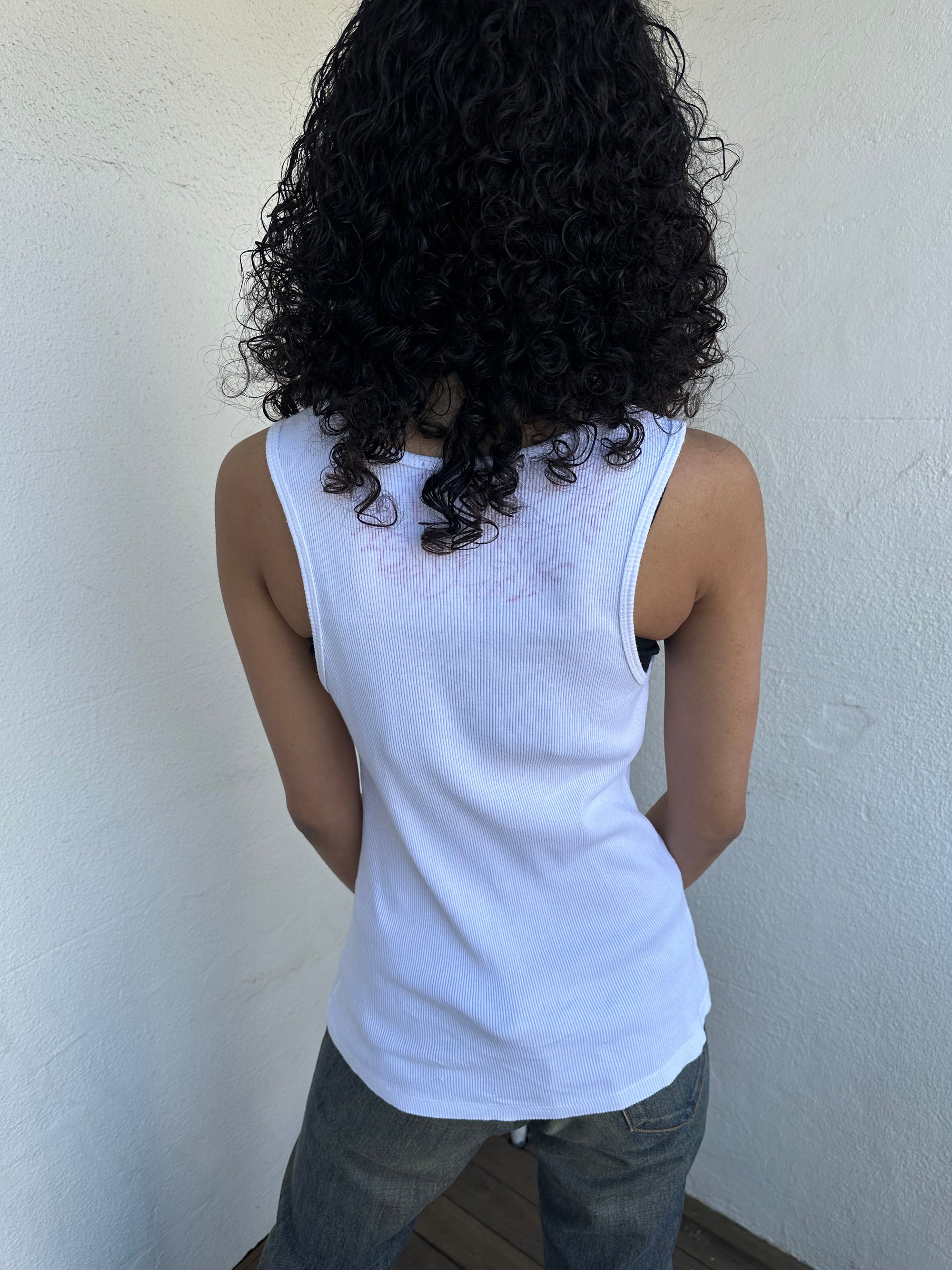 Woman wearing a Y2K 00s Hot pink flower print on white tank top features a vibrant floral graphic