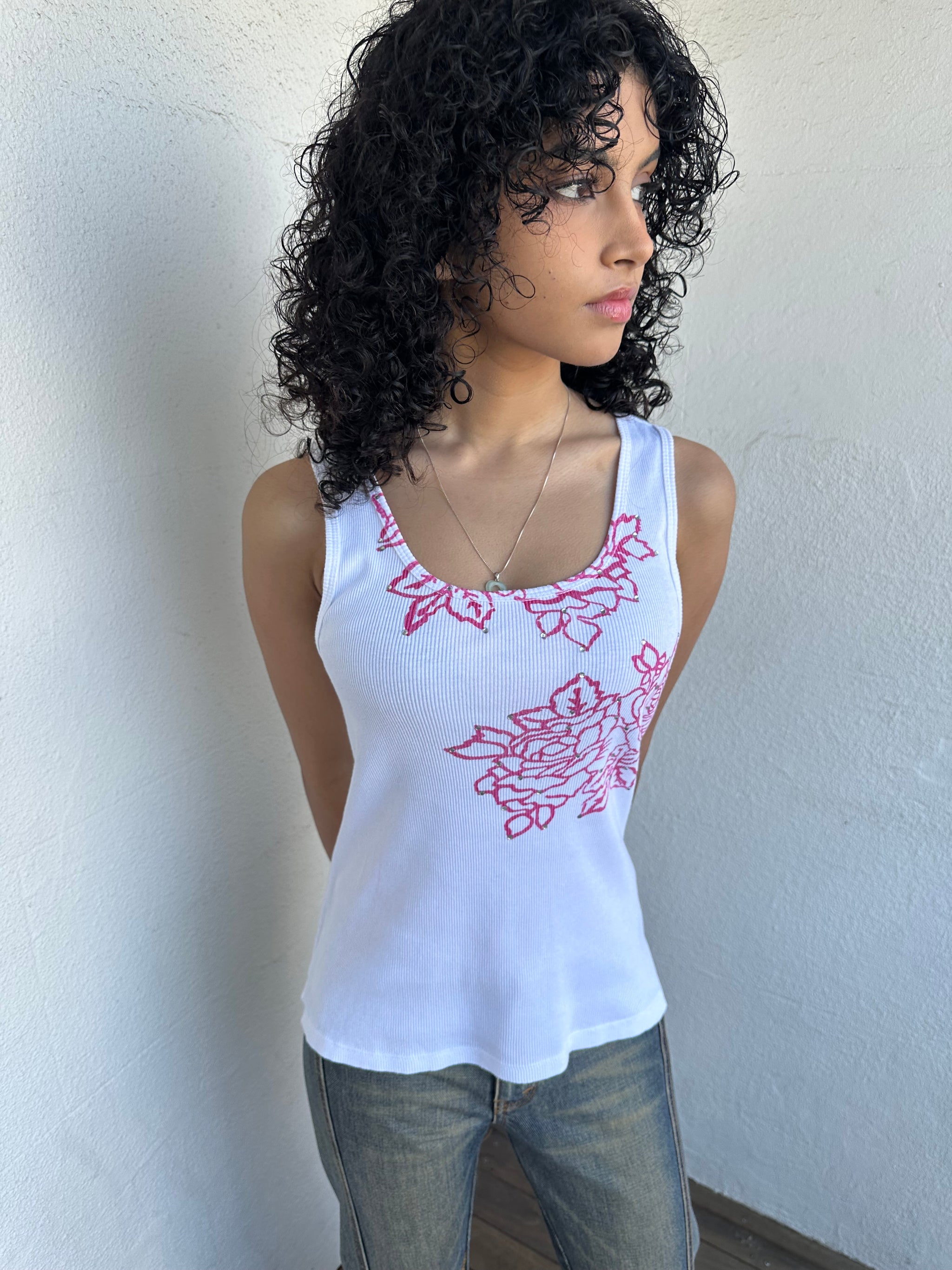 Woman wearing a Y2K 00s Hot pink flower print on white tank top features a vibrant floral graphic