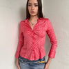 Woman wearing a Y2K 00s Pink pinstripe fitted shirt with a tailored silhouette and with a subtle shimmer to it.