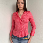 Woman wearing a Y2K 00s Pink pinstripe fitted shirt with a tailored silhouette and with a subtle shimmer to it.