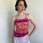 Woman Dressed in Y2K Pink and red patterned cami top featuring a red, pink, and cream mixed paisley and floral-style pattern.