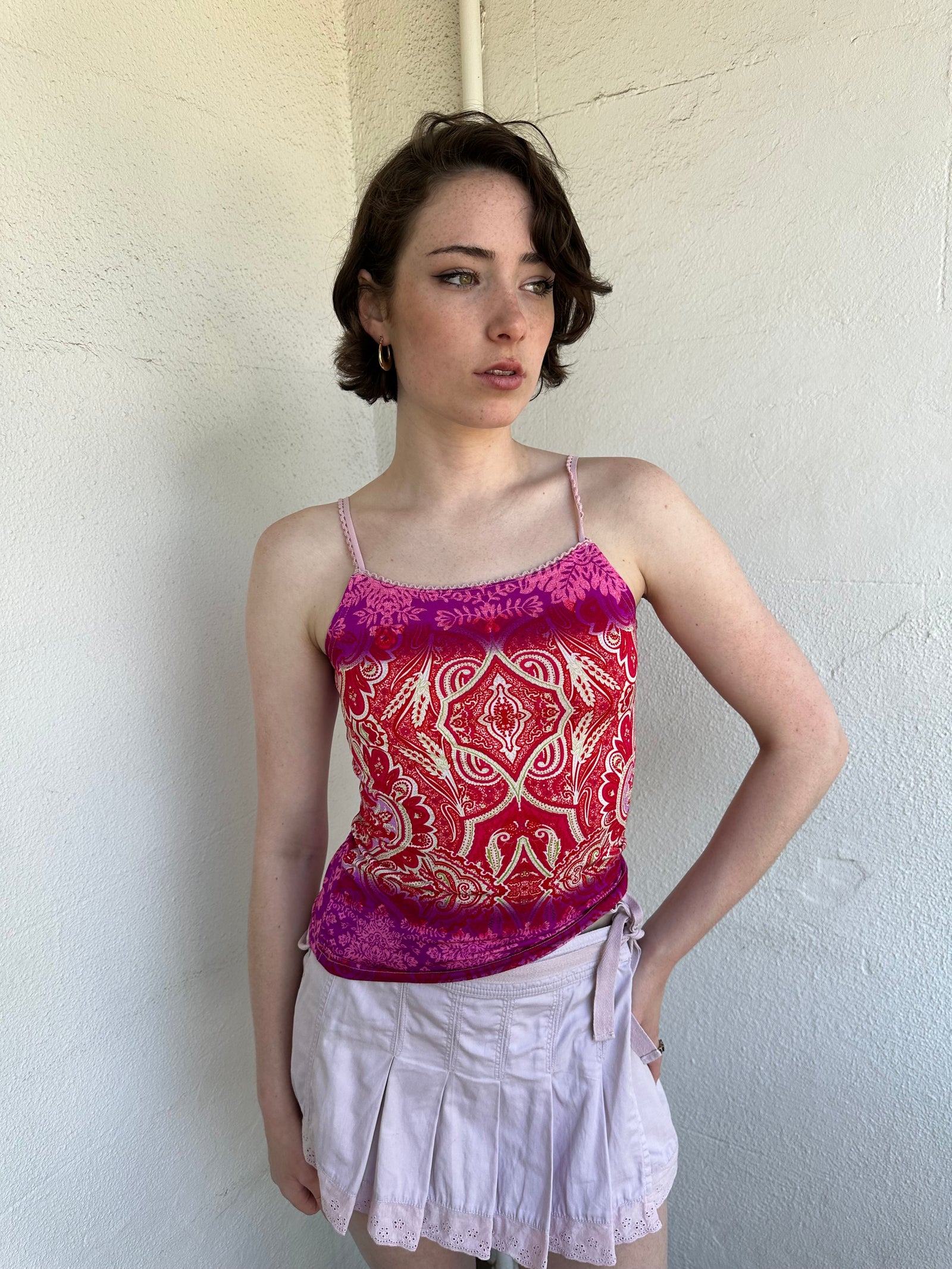 Woman Dressed in Y2K Pink and red patterned cami top featuring a red, pink, and cream mixed paisley and floral-style pattern.