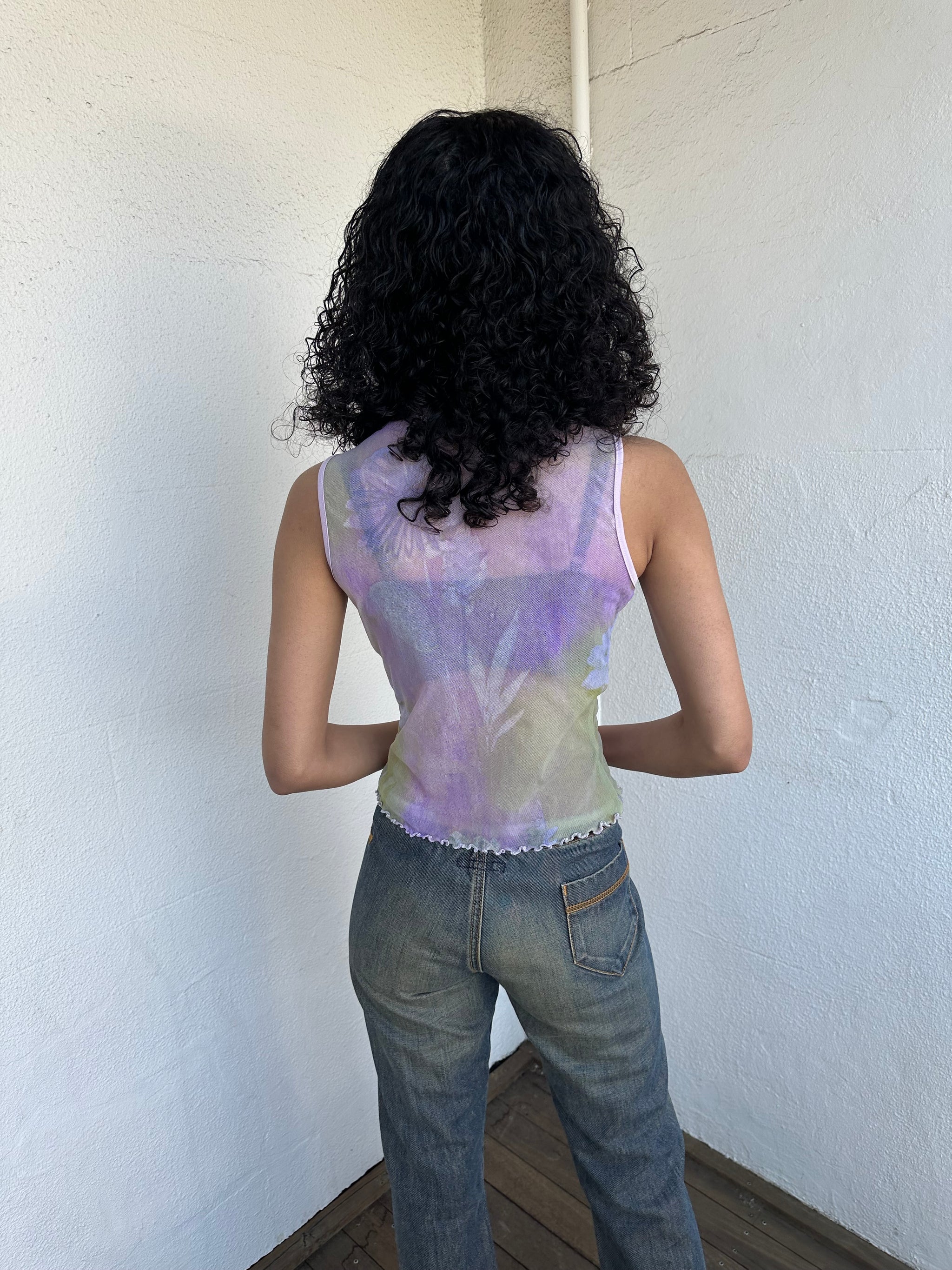 Woman Dressed in Y2K Purple and green flower print mesh tank that’s fully sheer with a soft, lightweight feel. 