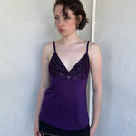 Woman Dressed in Y2K Purple Y2K leopard print cami top featuring a bold sparkly animal print bust.