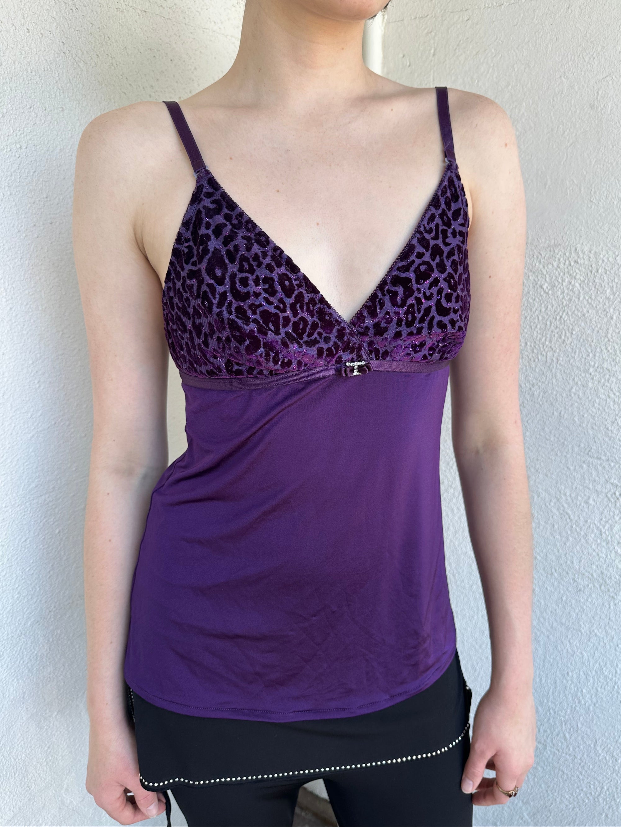 Woman Dressed in Y2K Purple Y2K leopard print cami top featuring a bold sparkly animal print bust.