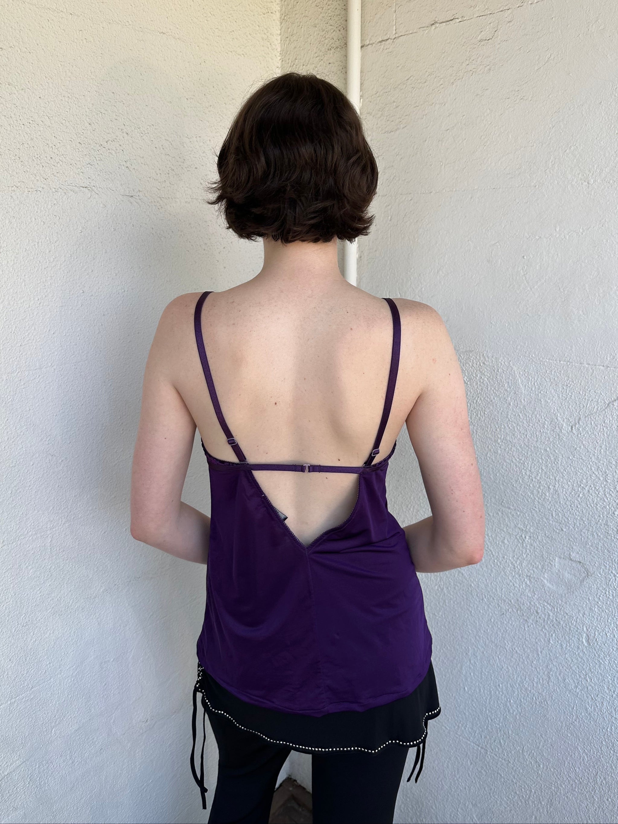 Woman Dressed in Y2K Purple Y2K leopard print cami top featuring a bold sparkly animal print bust.