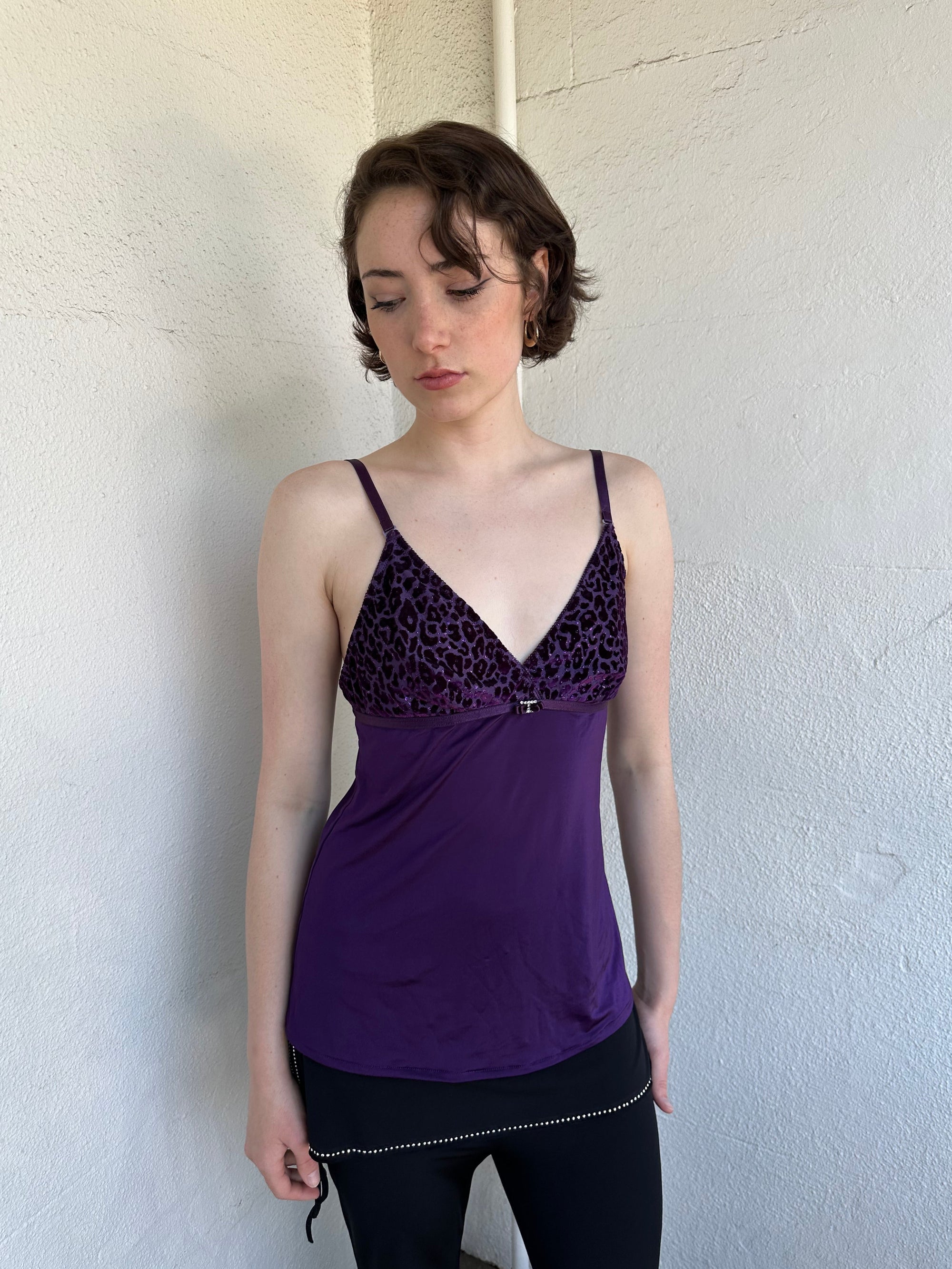 Woman Dressed in Y2K Purple Y2K leopard print cami top featuring a bold sparkly animal print bust.