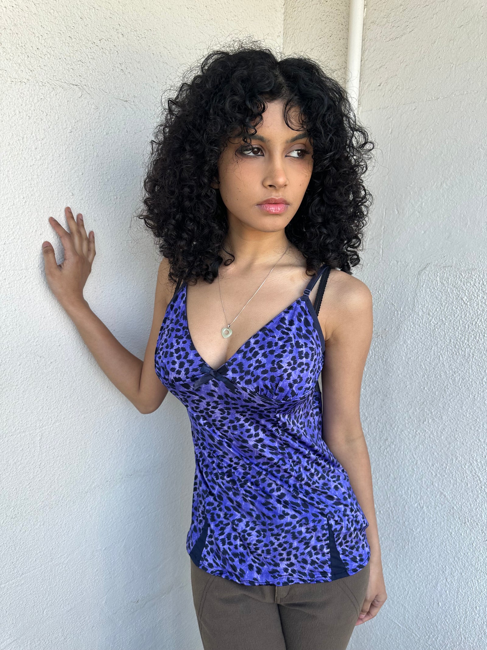 Woman wearing a Y2K 90s Purple leopard print cami with a soft, lightweight feel and slim fit.