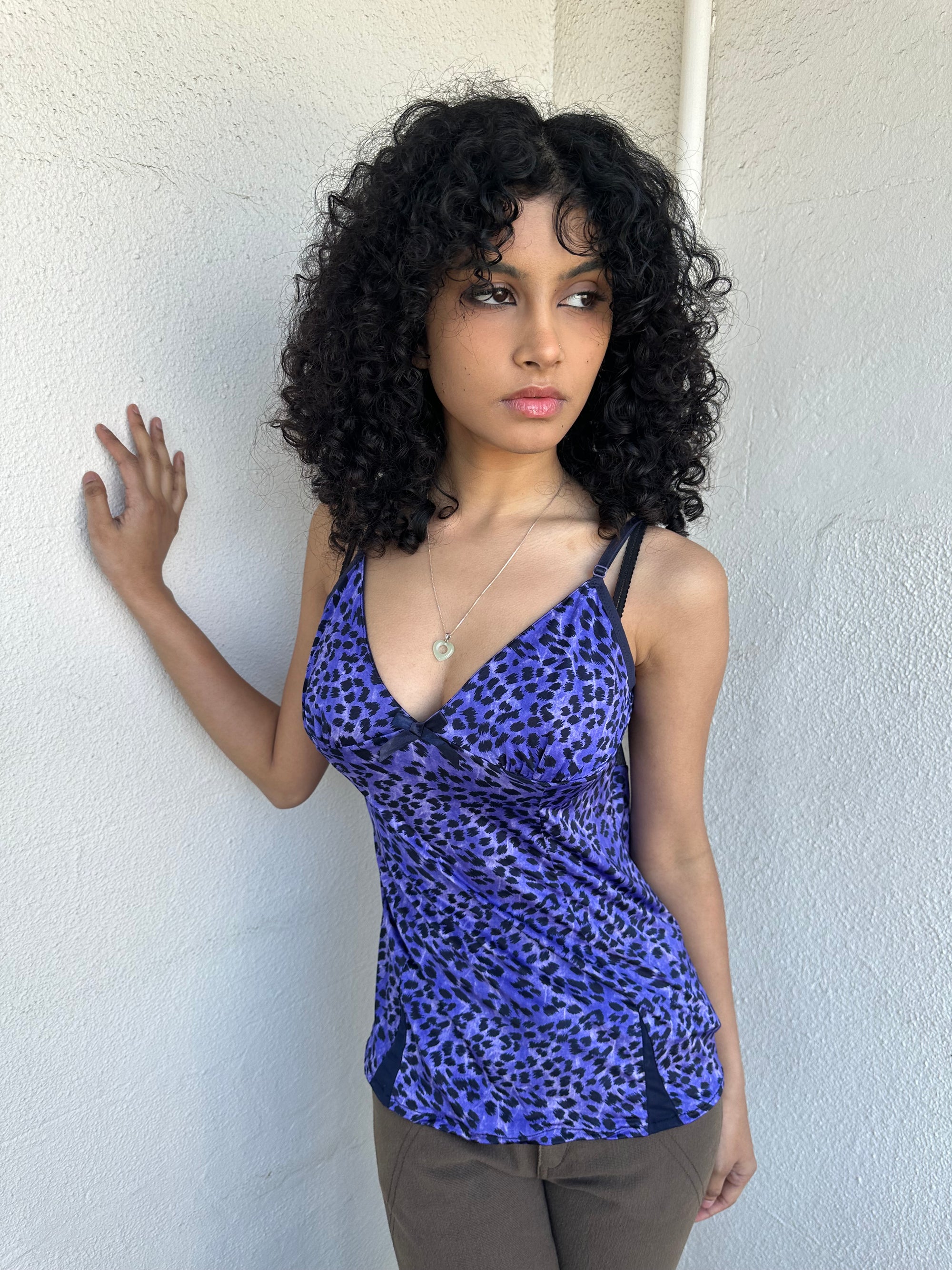 Woman wearing a Y2K 90s Purple leopard print cami with a soft, lightweight feel and slim fit.
