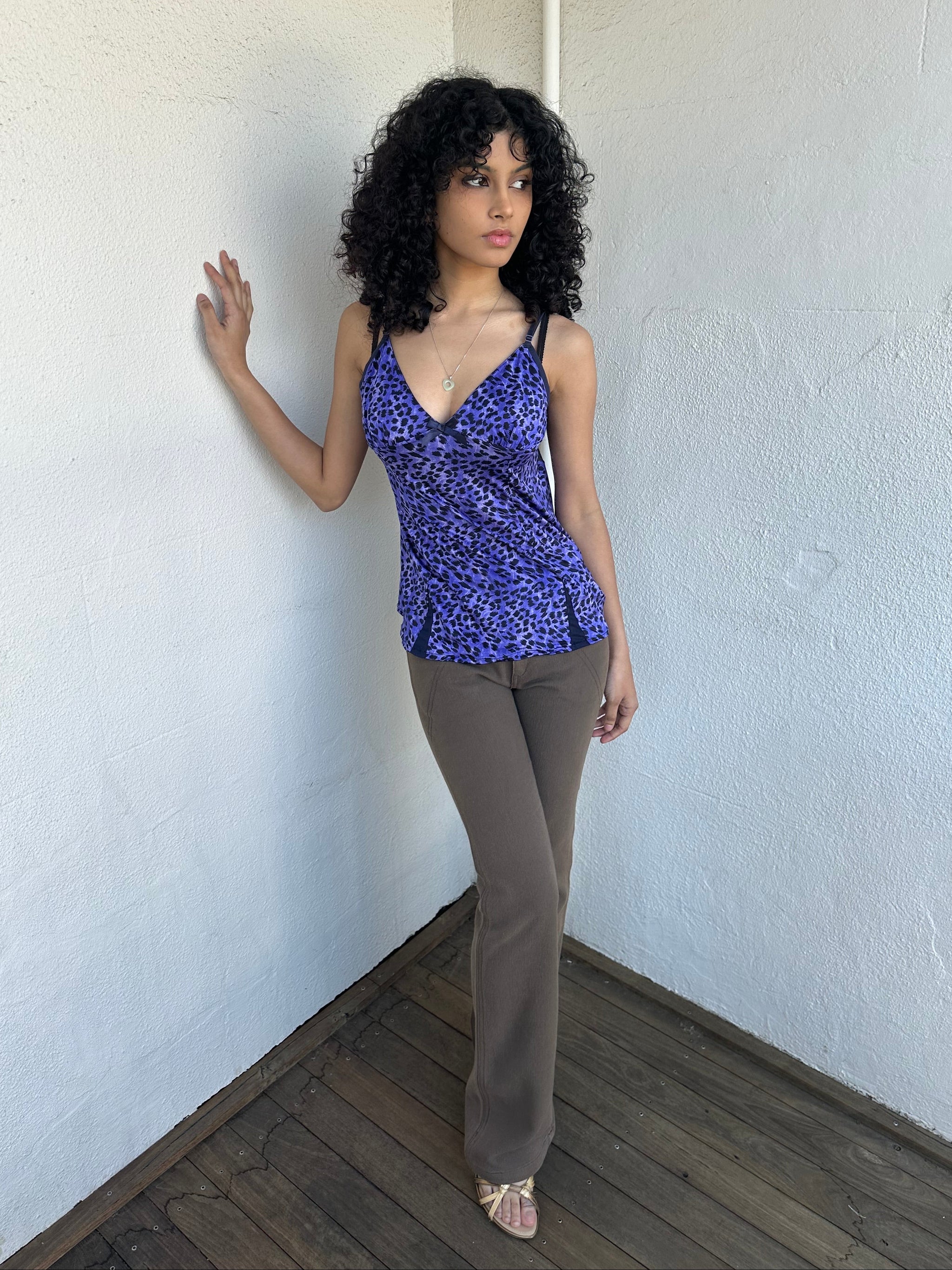 Woman wearing a Y2K 90s Purple leopard print cami with a soft, lightweight feel and slim fit.