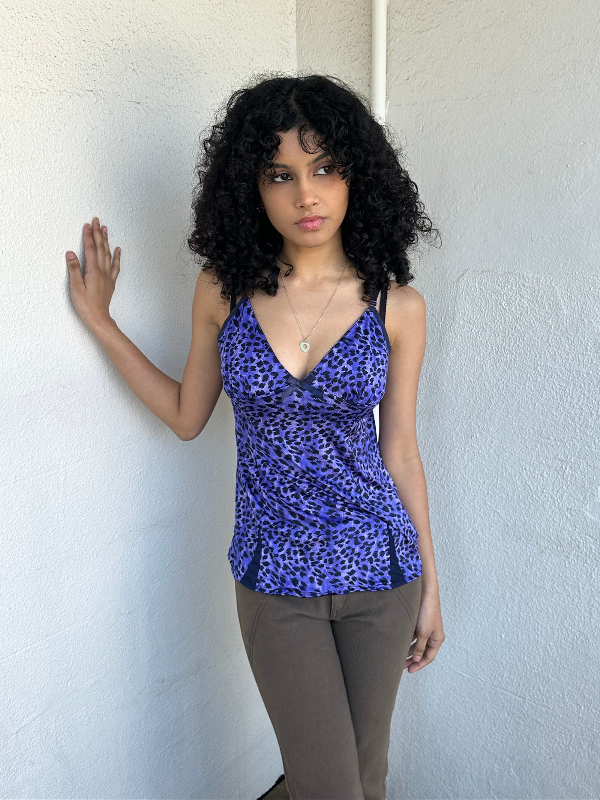 Woman wearing a Y2K 90s Purple leopard print cami with a soft, lightweight feel and slim fit.
