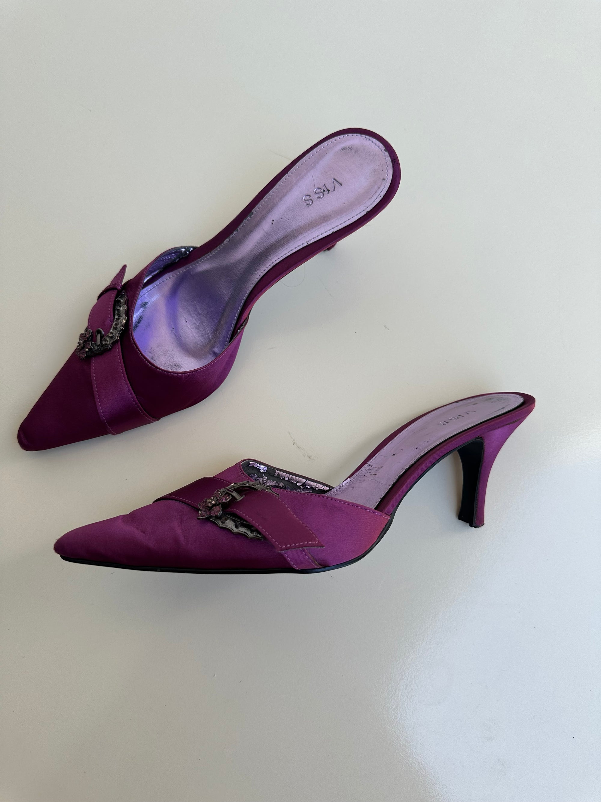 Woman Dressed in Y2K 00s pink, purple satin kitten heels featuring a sleek satin finish in a rich purple tone
