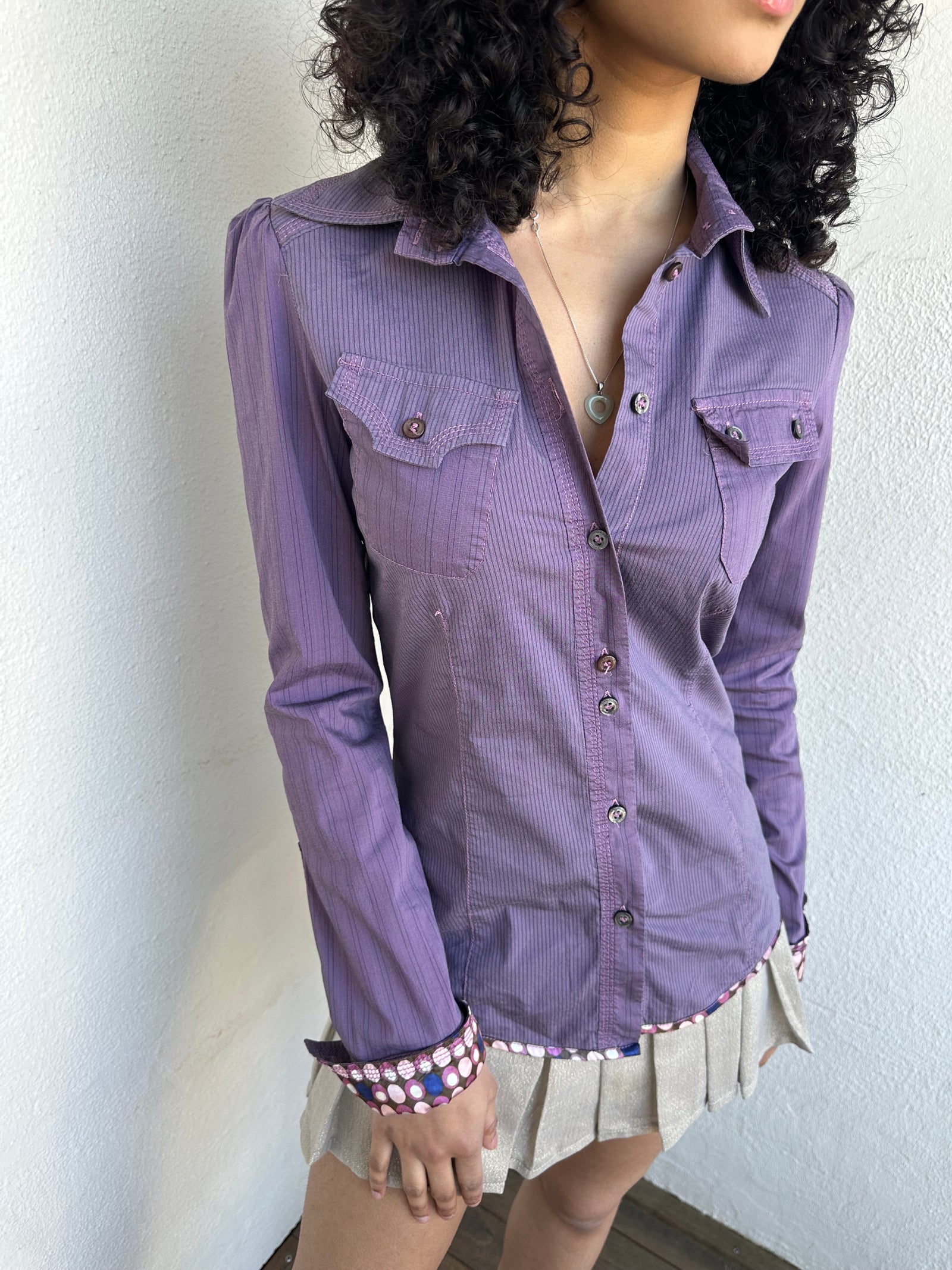 Woman wearing a Y2K 00s Purple stripe and polkadot shirt, pinstripe fabric with contrasting polkadot cuffs and trim hem