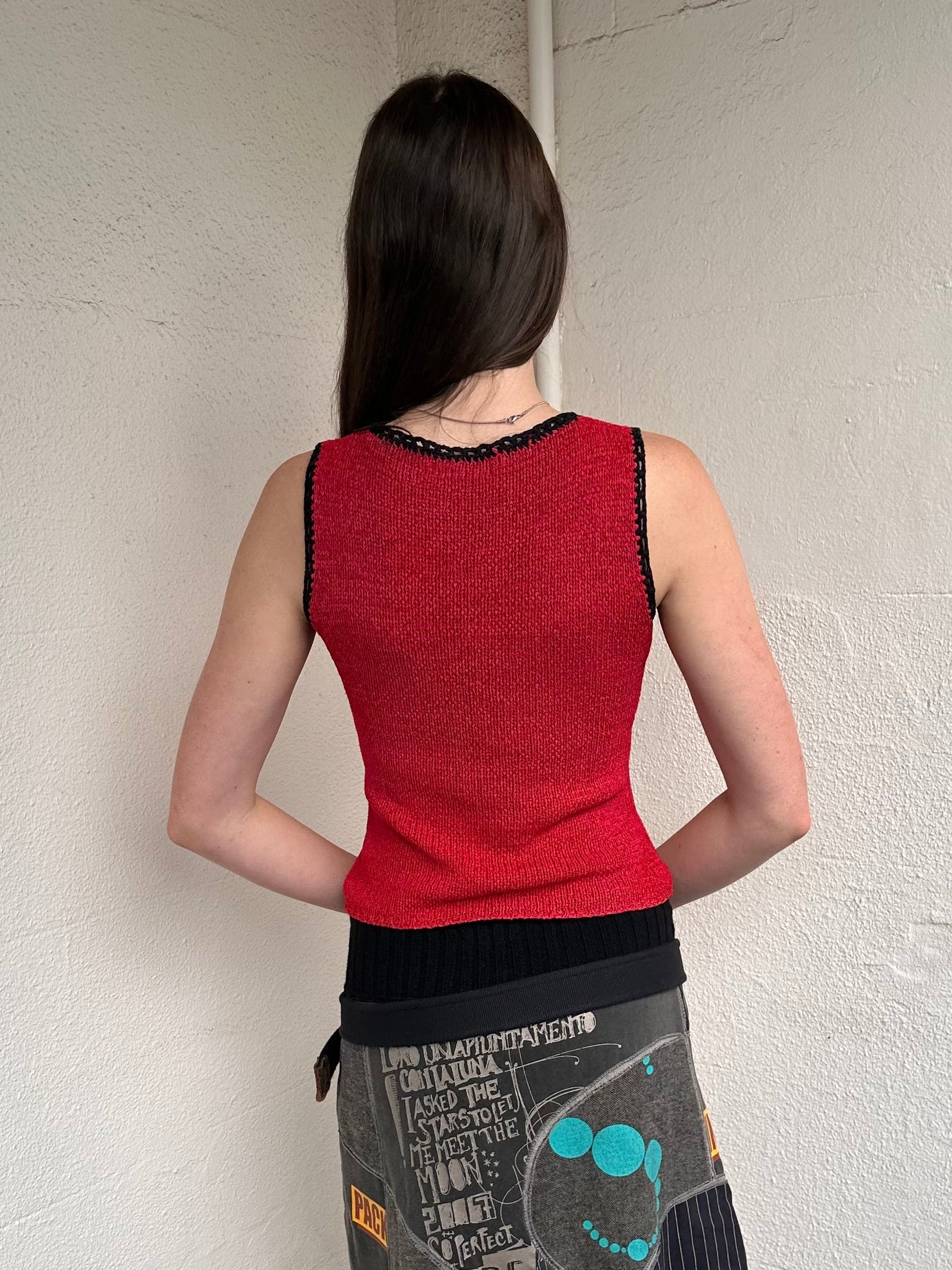 Woman wearing a Y2K 00s Black with white floral embroidery mesh cami top. Light blue floral embroidery featured 