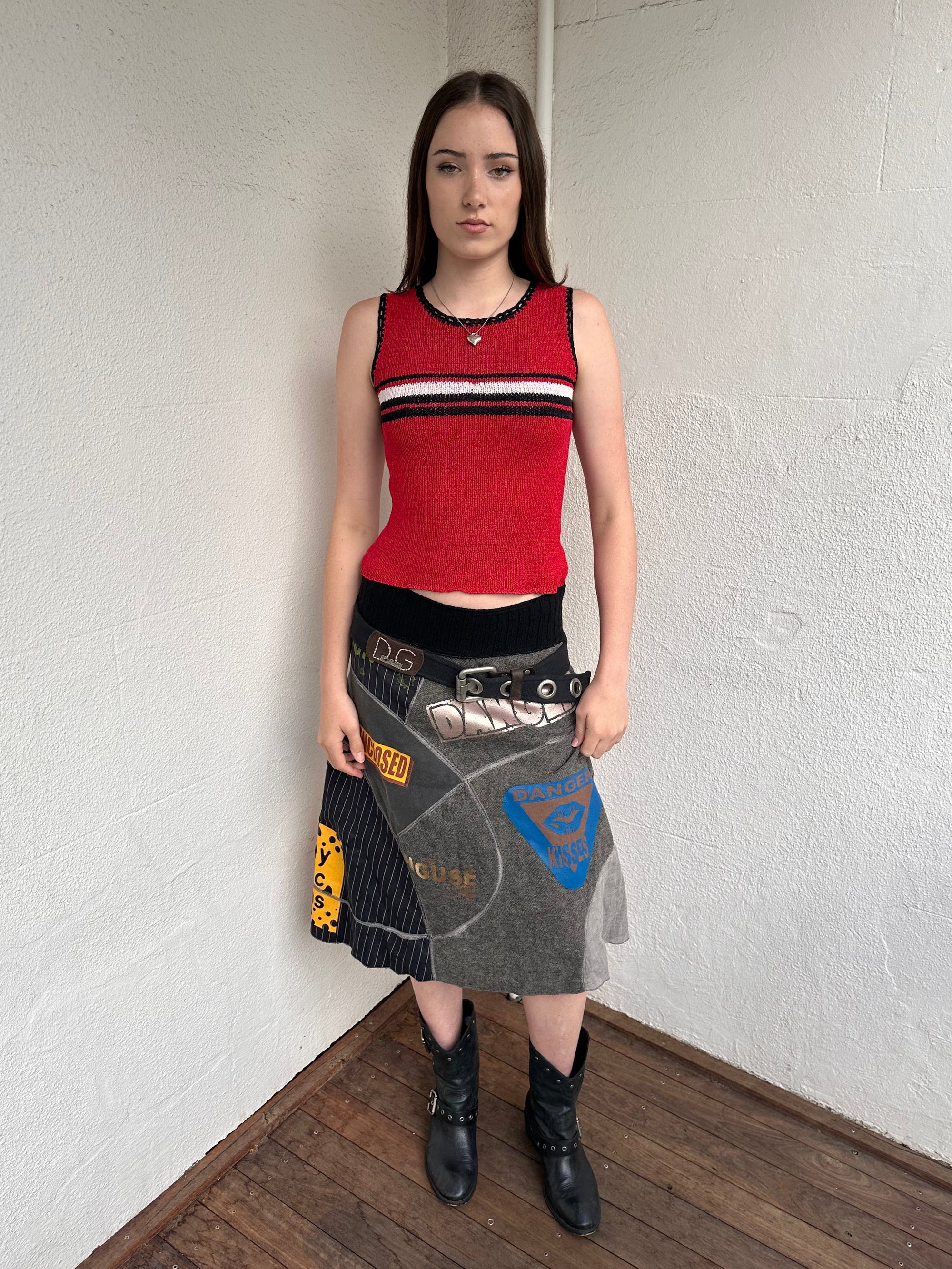 Woman wearing a Y2K 00s Black with white floral embroidery mesh cami top. Light blue floral embroidery featured 