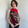 Woman Dressed in Y2K Red and black patchwork floral top featuring a mixed floral patchwork design in red and black tones with silver square ring detailing throughout.
