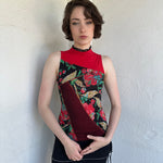 Woman Dressed in Y2K Red and black patchwork floral top featuring a mixed floral patchwork design in red and black tones with silver square ring detailing throughout.