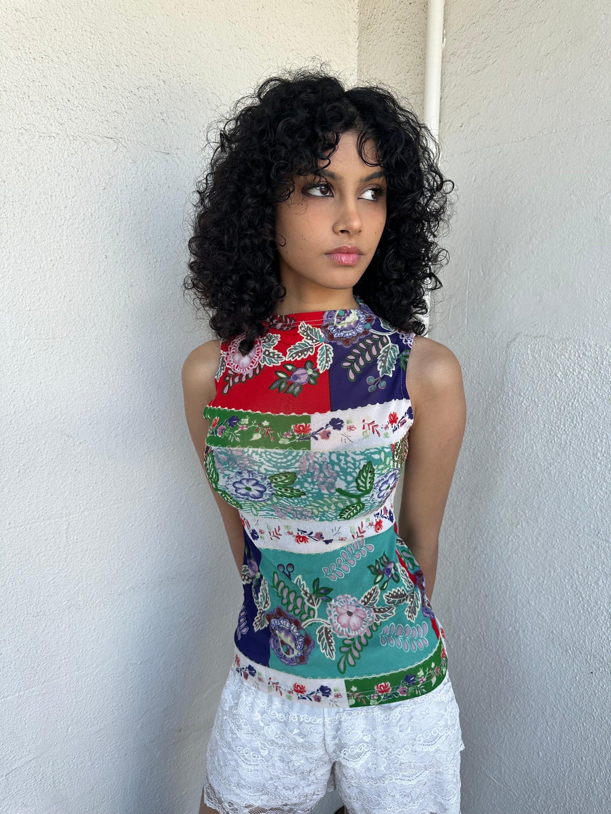 Women wearing a 00s Y2K Red, green, white and blue floral patchwork tank top in a sleeveless high-neck mesh design. 