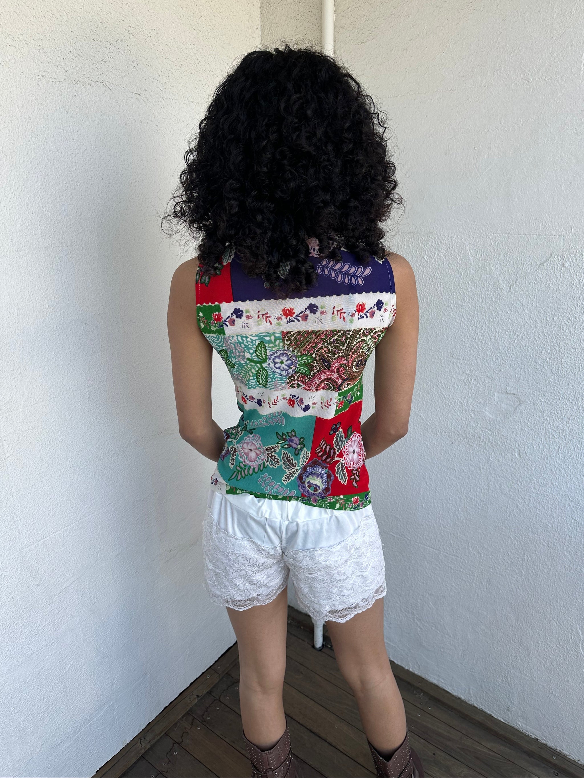 Women wearing a 00s Y2K Red, green, white and blue floral patchwork tank top in a sleeveless high-neck mesh design. 