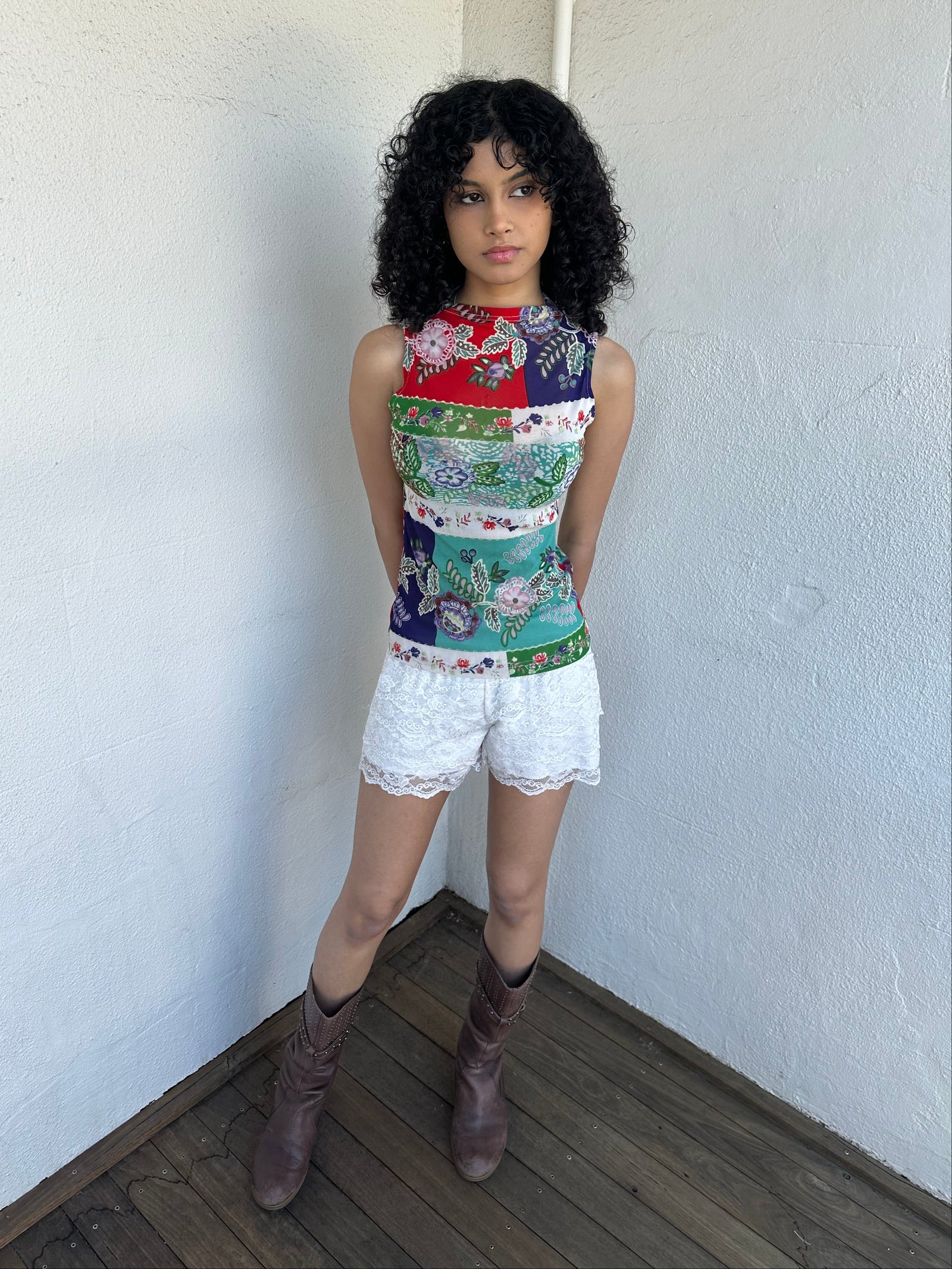 Women wearing a 00s Y2K Red, green, white and blue floral patchwork tank top in a sleeveless high-neck mesh design. 
