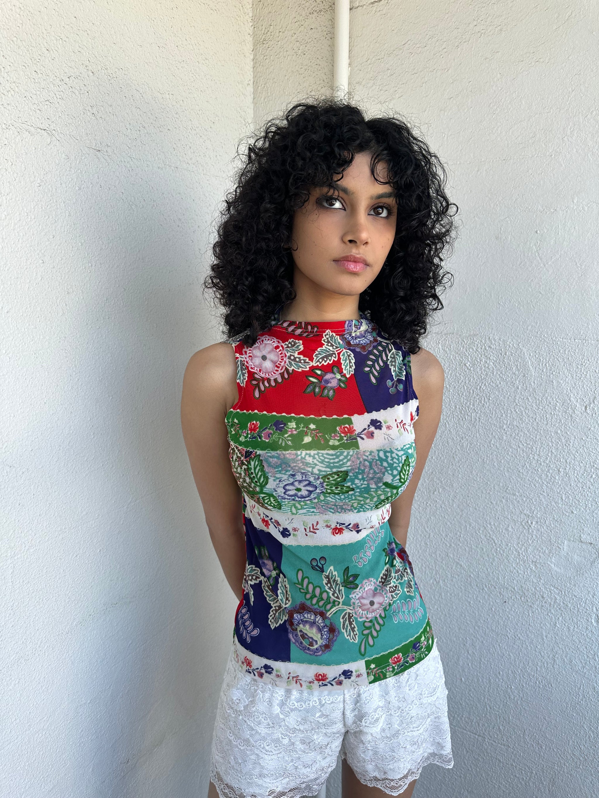 Women wearing a 00s Y2K Red, green, white and blue floral patchwork tank top in a sleeveless high-neck mesh design. 