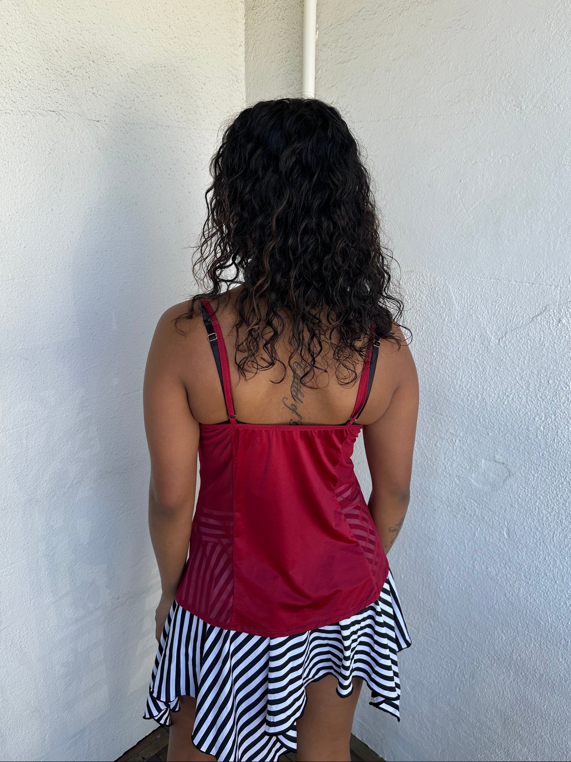 Woman Dressed in Y2K 00s Red mesh panel cami featuring sheer mesh panels along the sides and an embroidered bust 