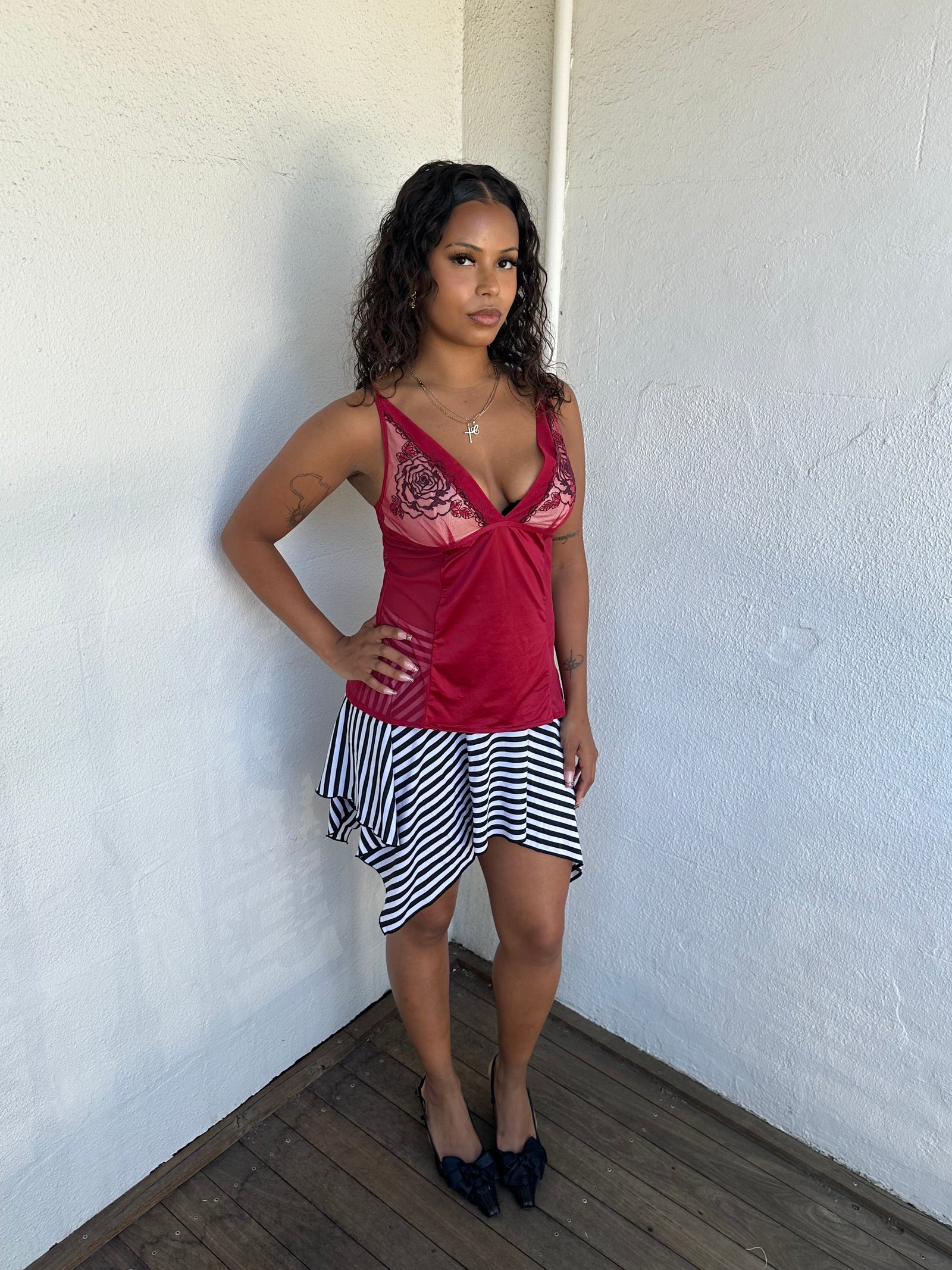 Woman Dressed in Y2K 00s Red mesh panel cami featuring sheer mesh panels along the sides and an embroidered bust 