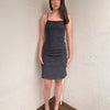 Woman wearing a Y2K 00s Red trimmed dark denim midi dress with a fitted elegant cut.