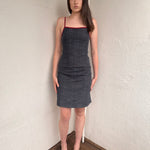 Woman wearing a Y2K 00s Red trimmed dark denim midi dress with a fitted elegant cut.
