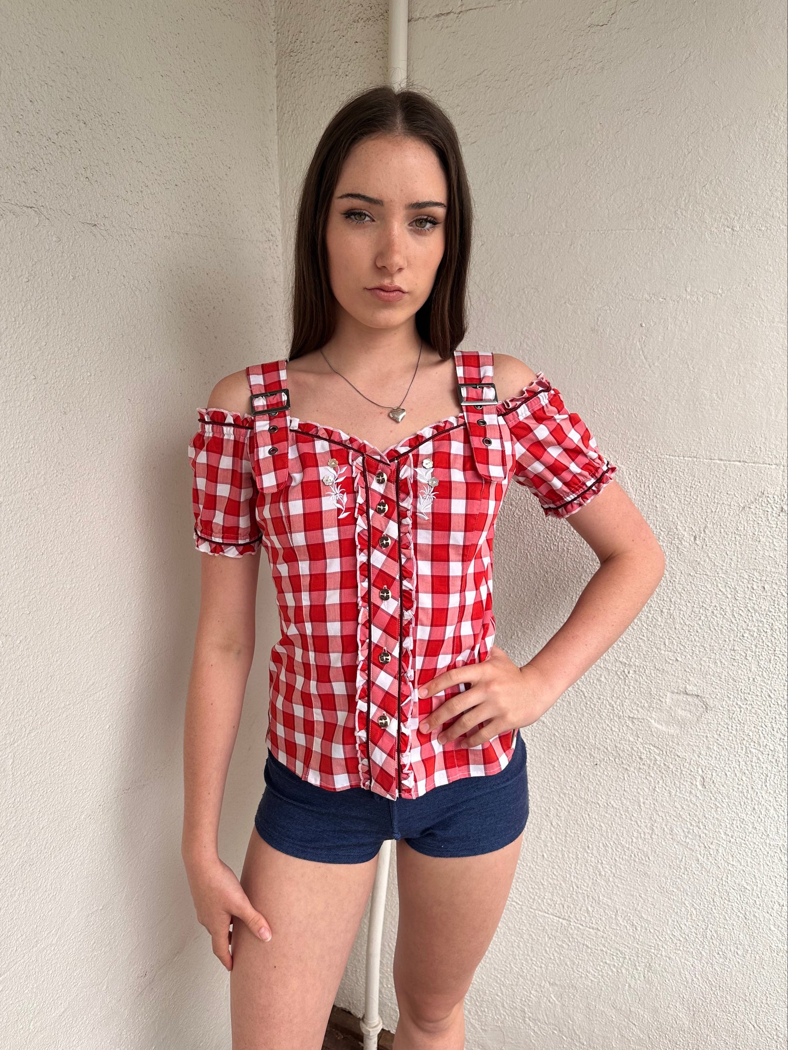 Women wearing a 00s Y2K Red and white checkered blouse with an off-the-shoulder design and chunky buckle straps. 