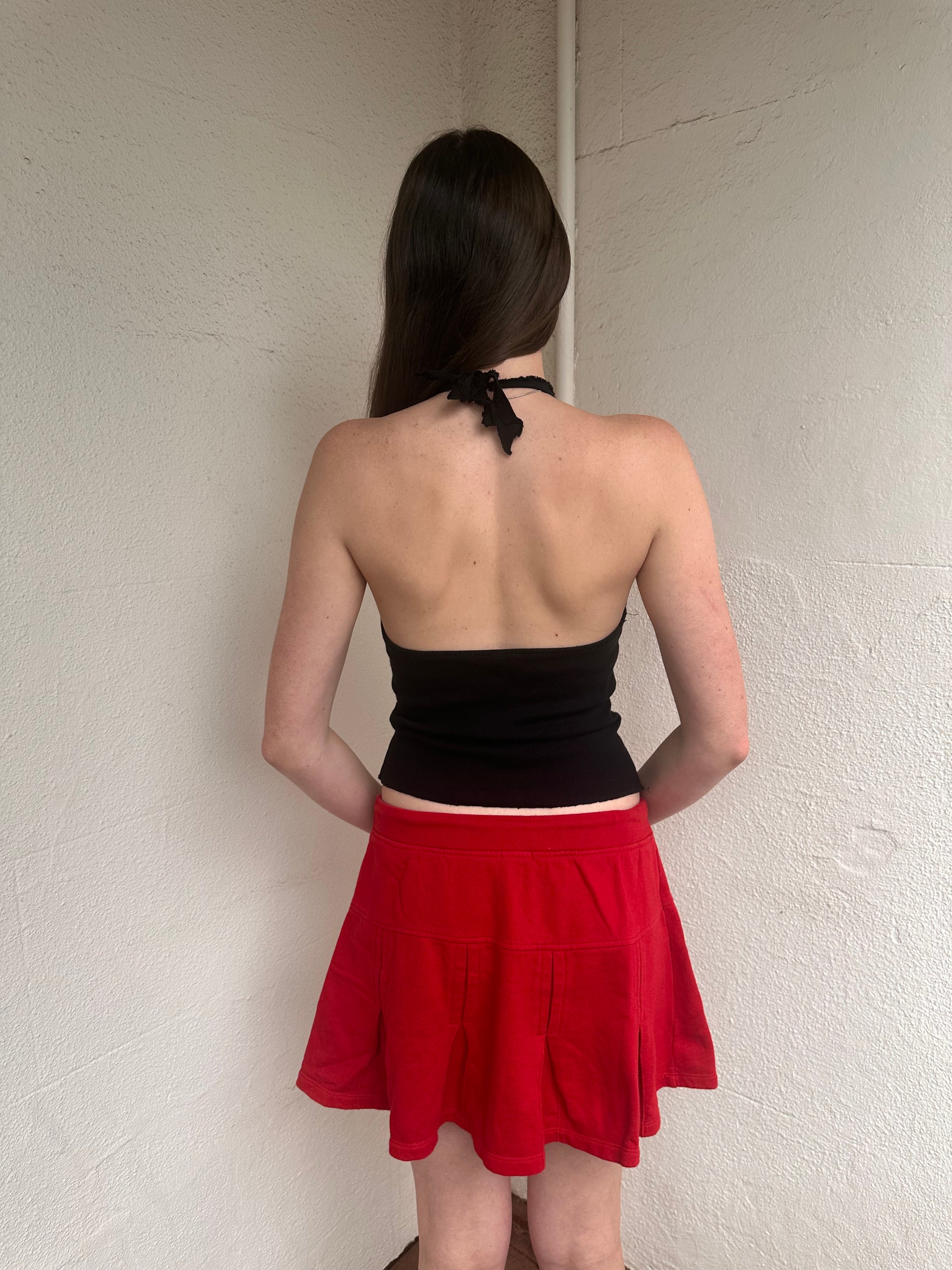 Woman wearing a Y2K 00s Red Drawstring Pleated Mini Skirt