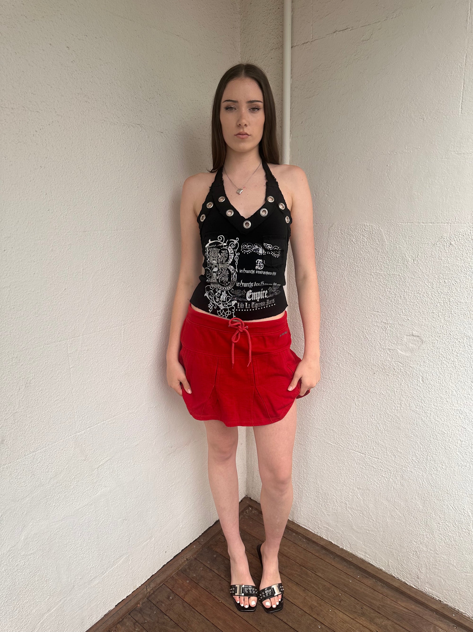 Woman wearing a Y2K 00s Red Drawstring Pleated Mini Skirt