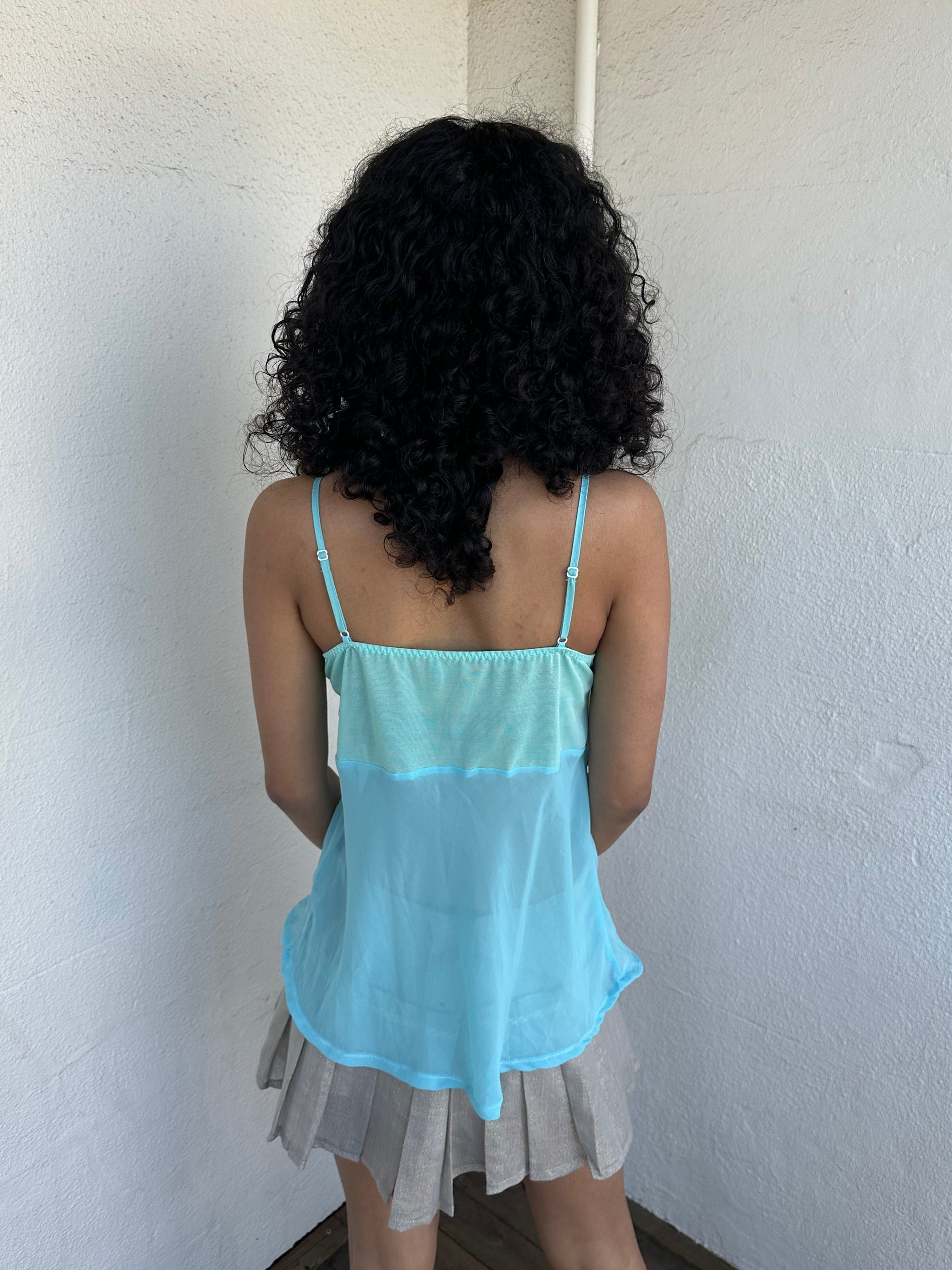 Women wearing a 00s Y2K Turquoise embroidered fairy cami with a lace bust featuring white and gold floral embroidery. 