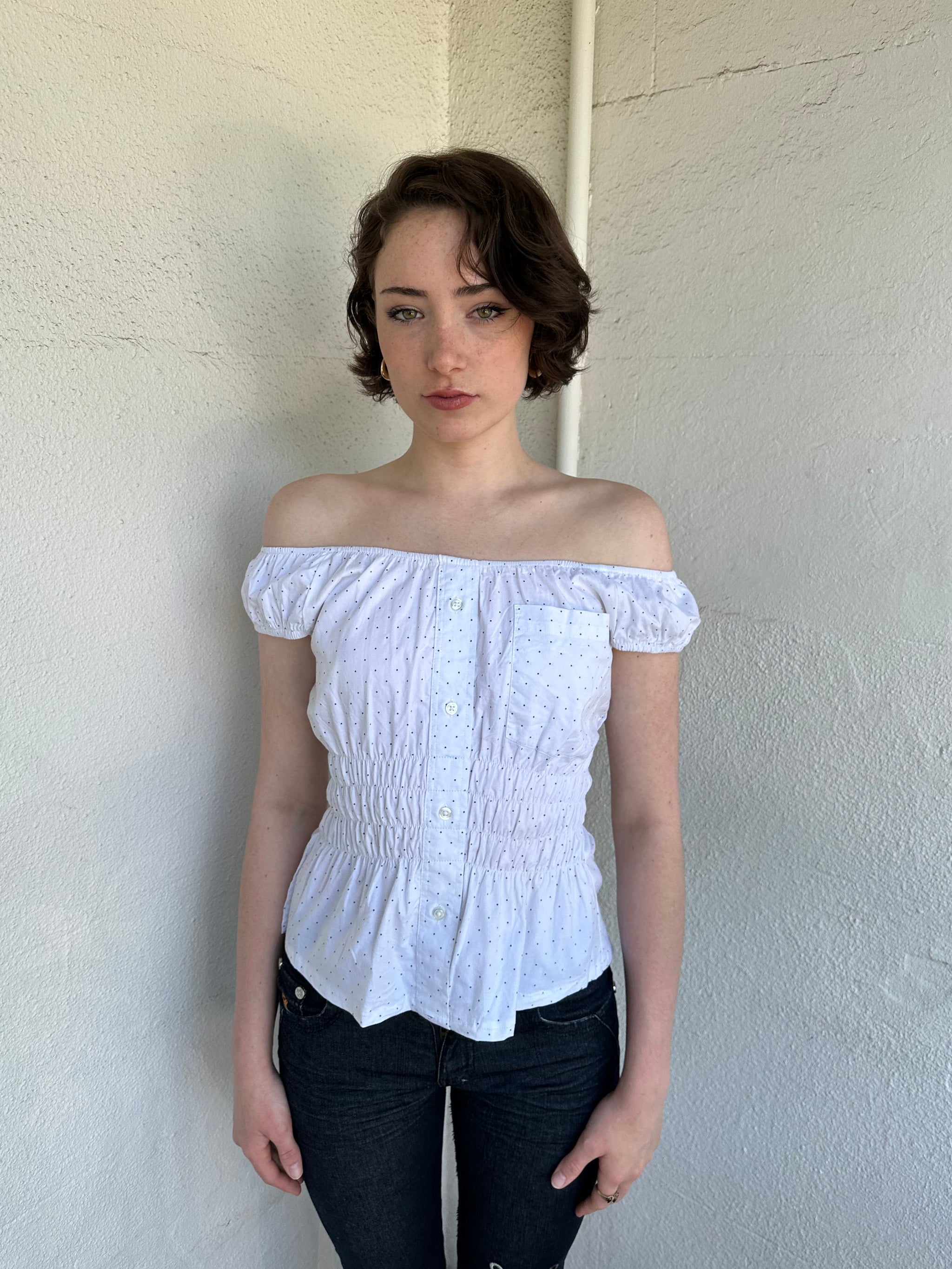 Woman Dressed in Y2K Reworked vintage shirt transformed into a summer classic white with black polka dot milkmaid style top 