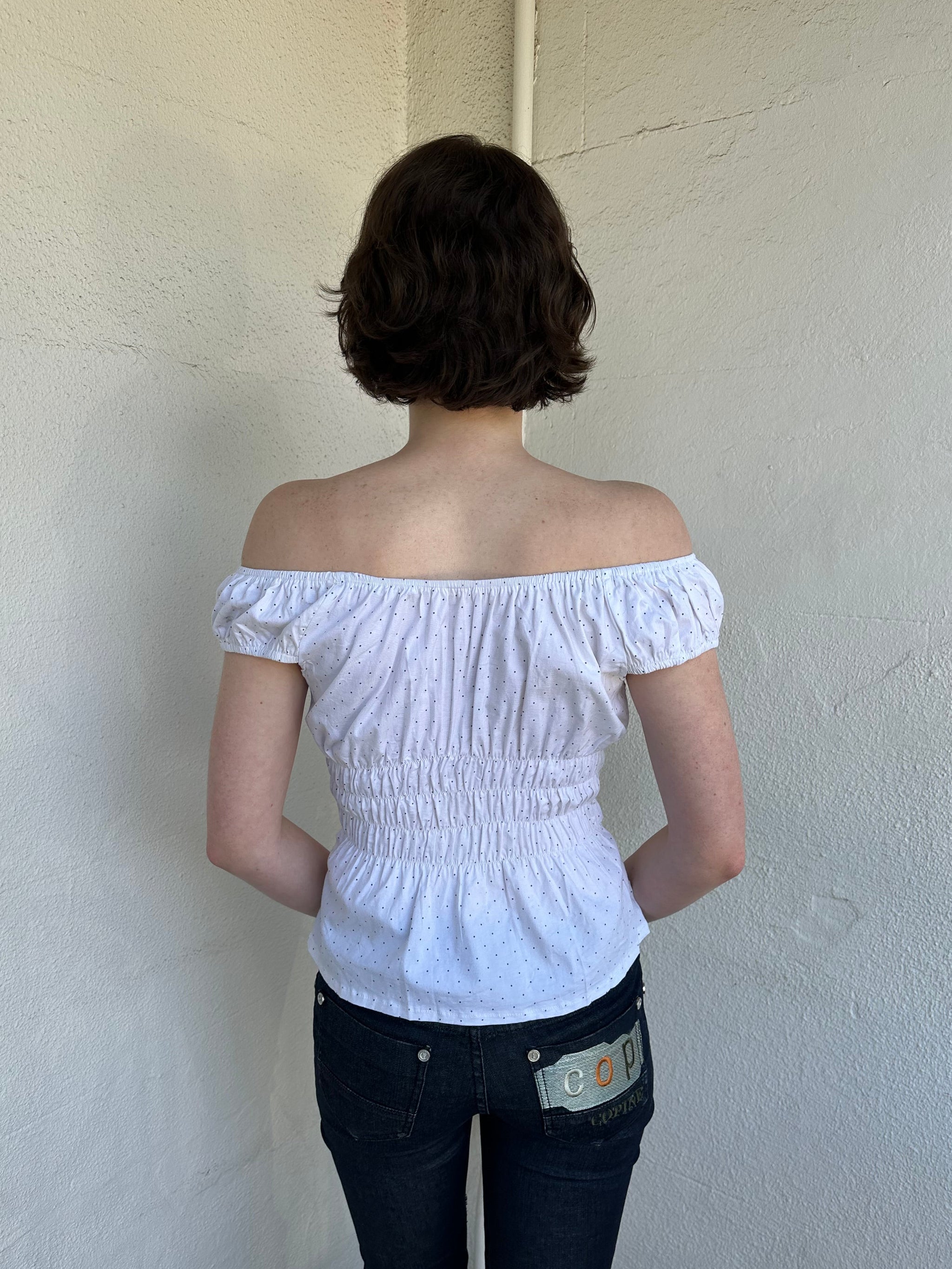 Woman Dressed in Y2K Reworked vintage shirt transformed into a summer classic white with black polka dot milkmaid style top 