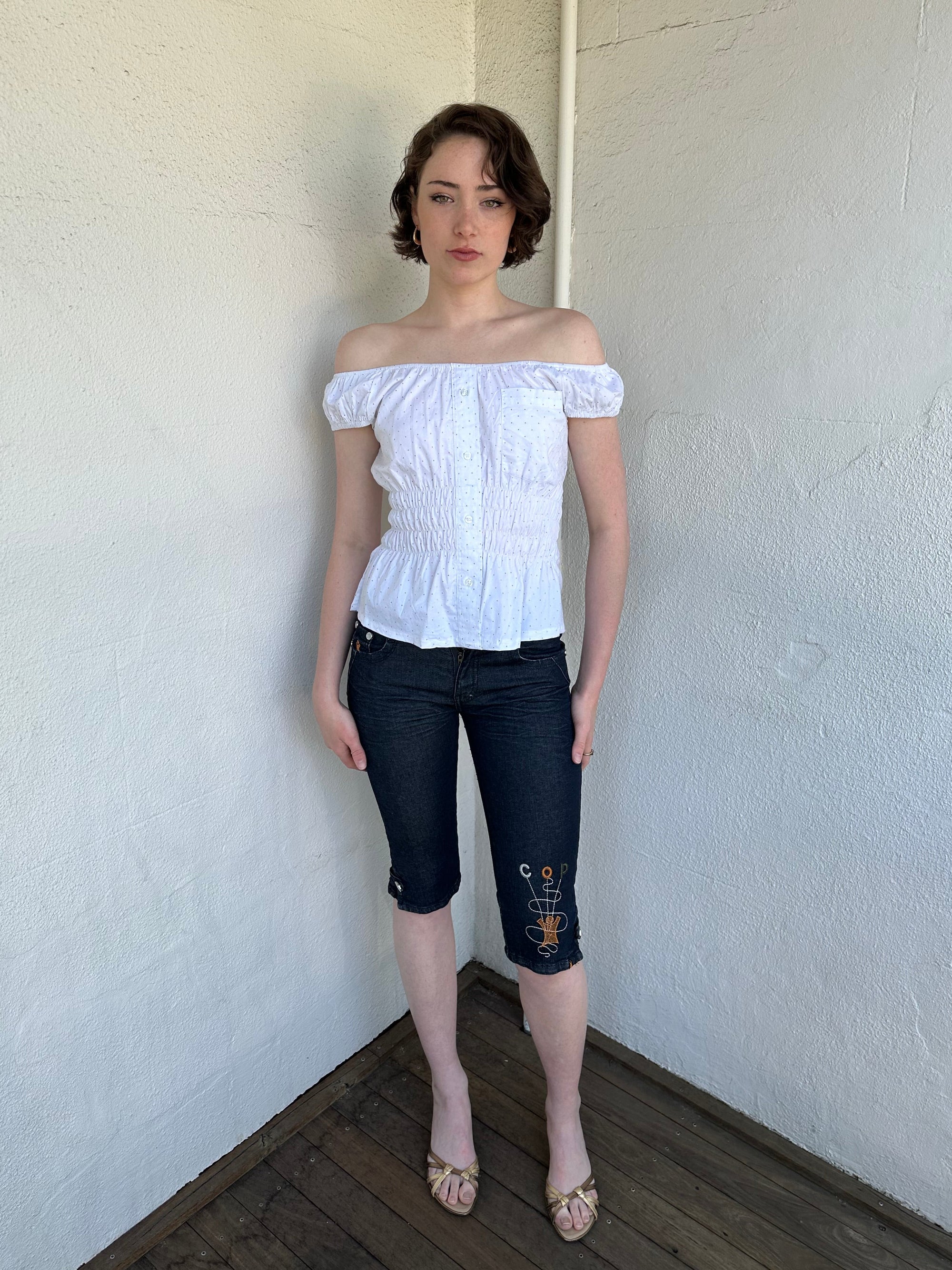 Woman Dressed in Y2K Reworked vintage shirt transformed into a summer classic white with black polka dot milkmaid style top 