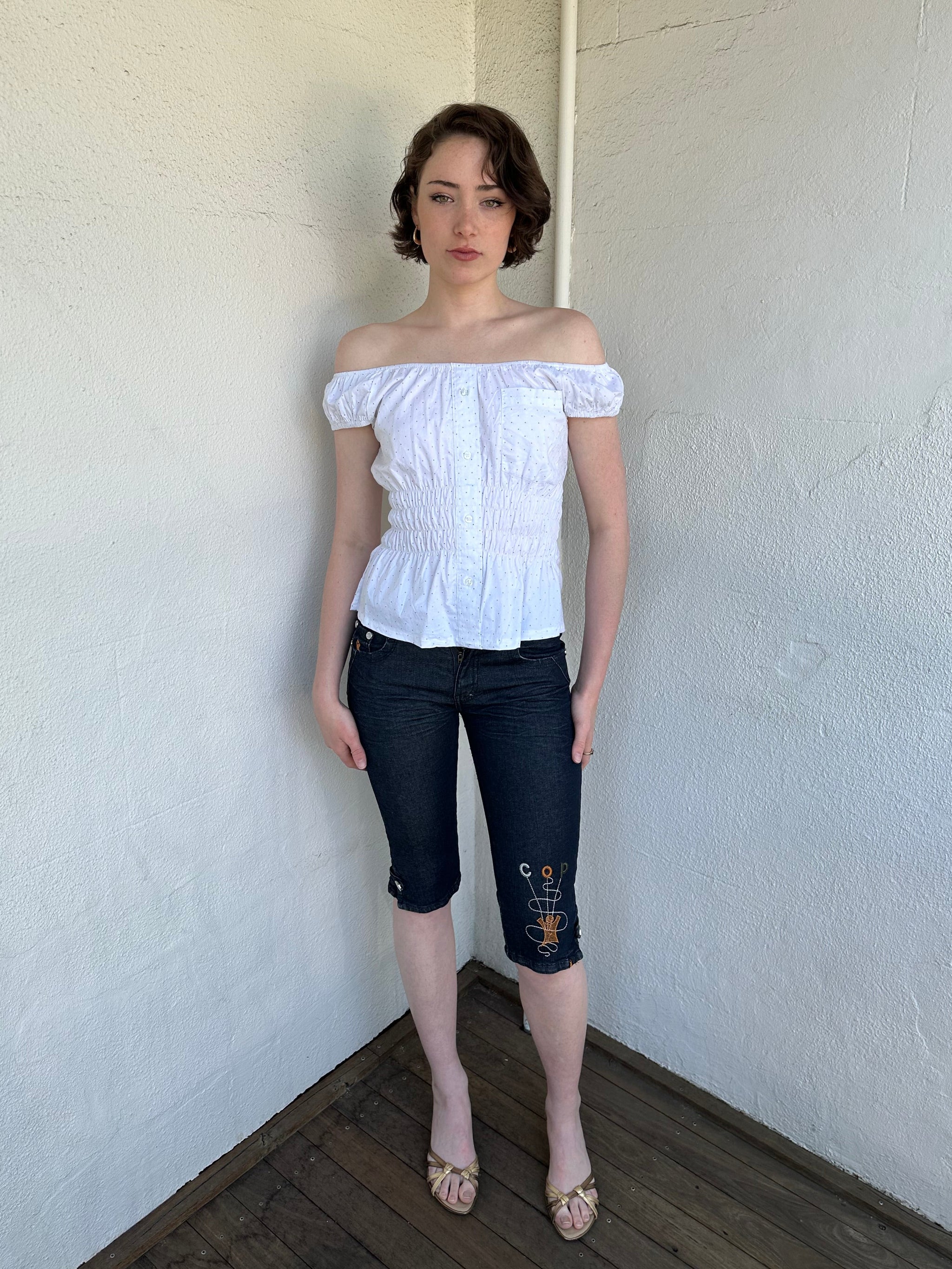 Woman Dressed in Y2K Reworked vintage shirt transformed into a summer classic white with black polka dot milkmaid style top 