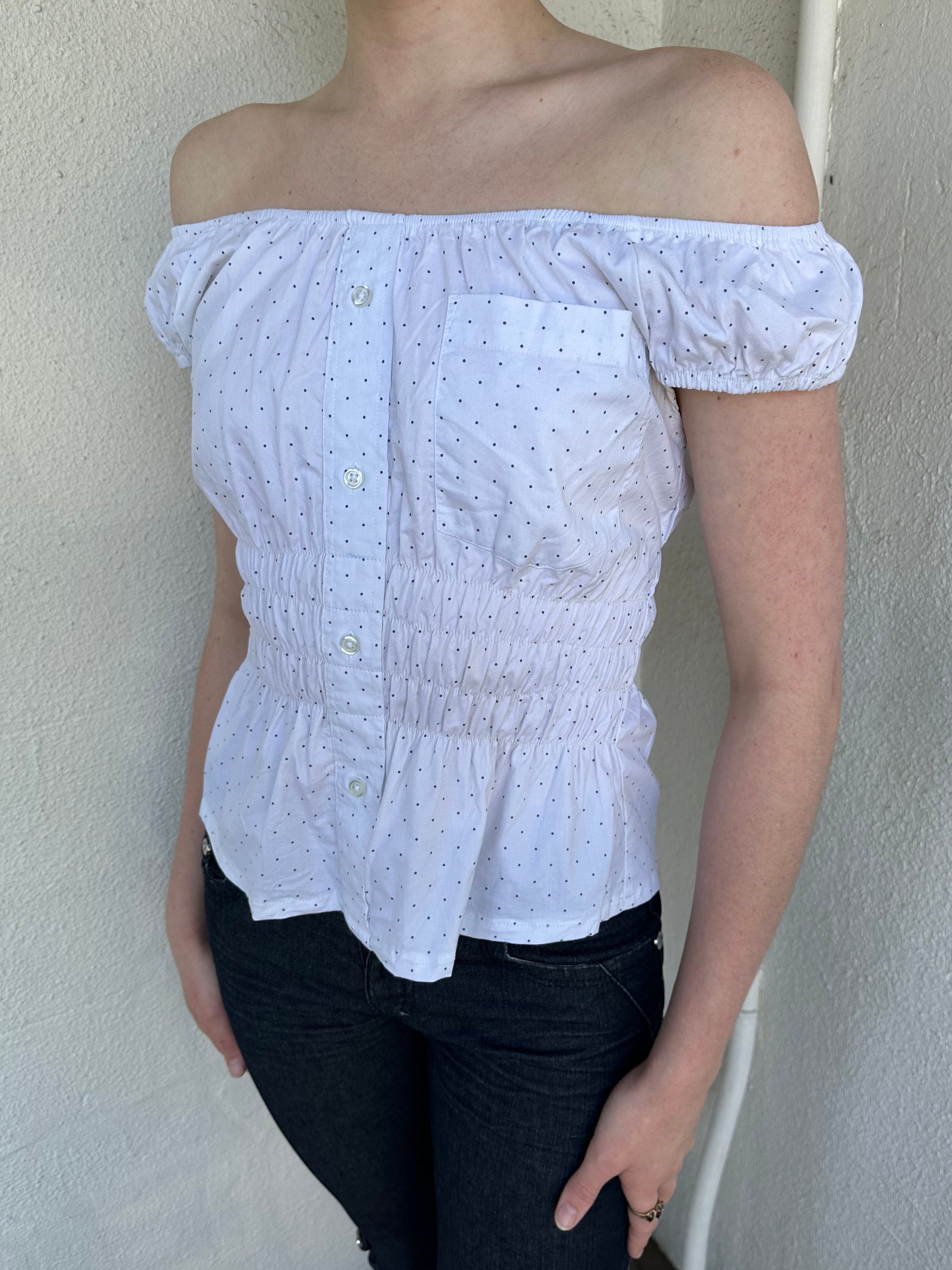 Woman Dressed in Y2K Reworked vintage shirt transformed into a summer classic white with black polka dot milkmaid style top 